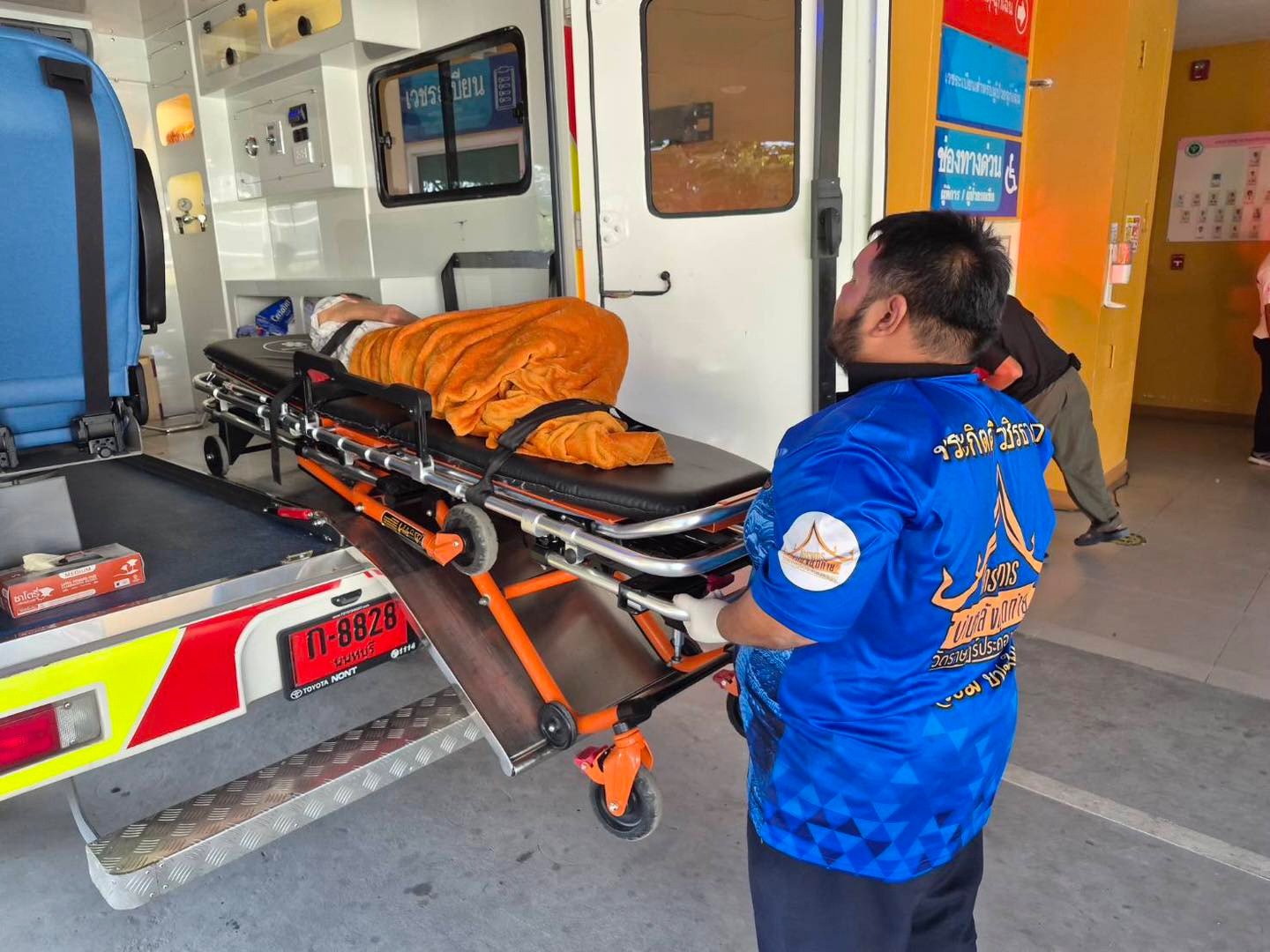 An emergency rescue team transport an elderly woman to a local hospital after she was found alive, having been declared deceased prior to her scheduled cremation on Sunday. Photo: Wat Rat Prakhong Tham/AP