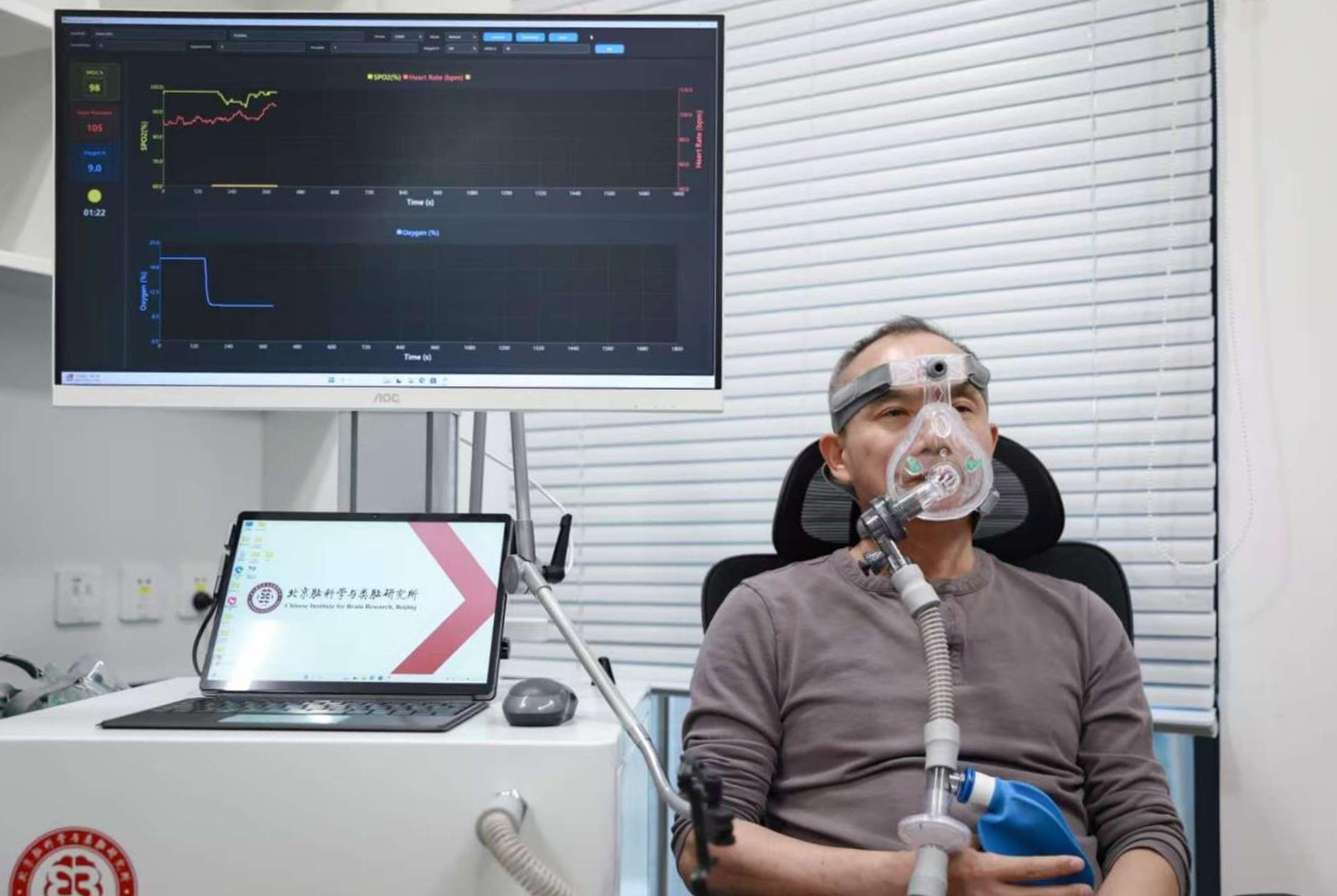 Luo Minmin from the Beijing Institute for Brain Research tests the acute intermittent hypoxia device developed by his team. Photo: Handout