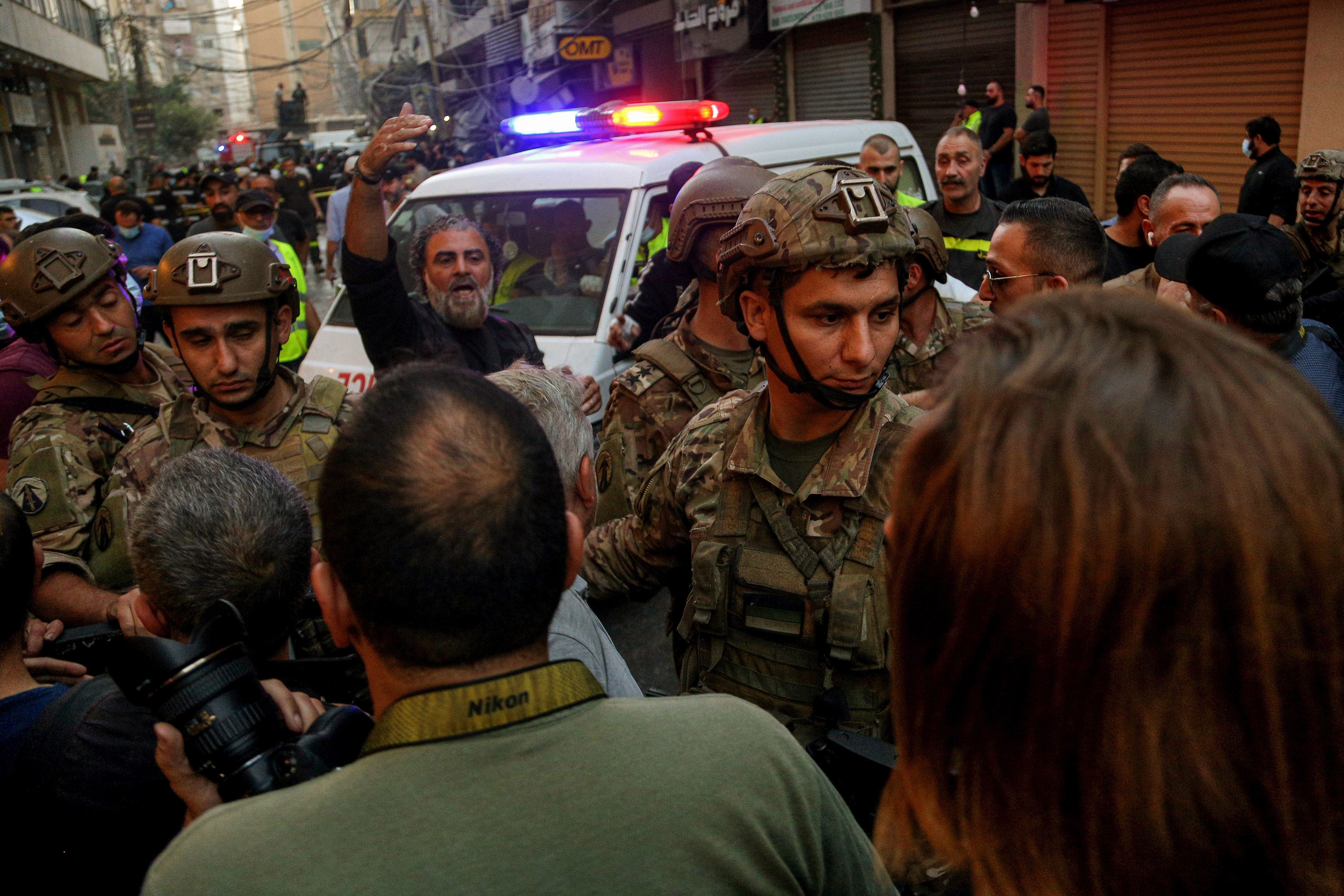Lebanese soldiers try to clear the way for an ambulance at the site where an Israeli air strike hit a building in southern Beirut on Sunday. Photo: dpa