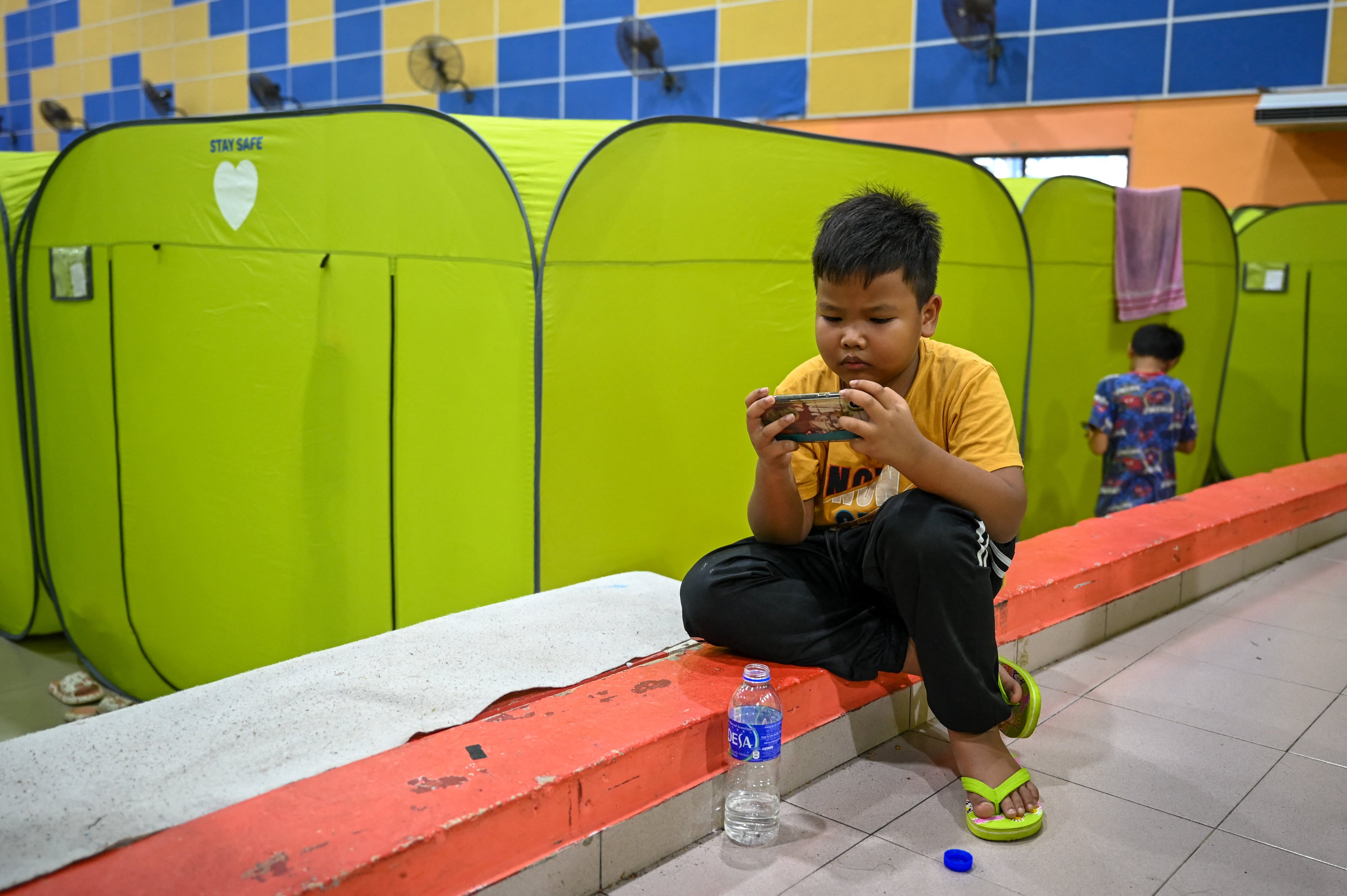 A young boy looks at a mobile phone in Malaysia’s Johor state. The push to bar children from social media follows a string of troubling incidents including viral bullying videos. Photo: AFP