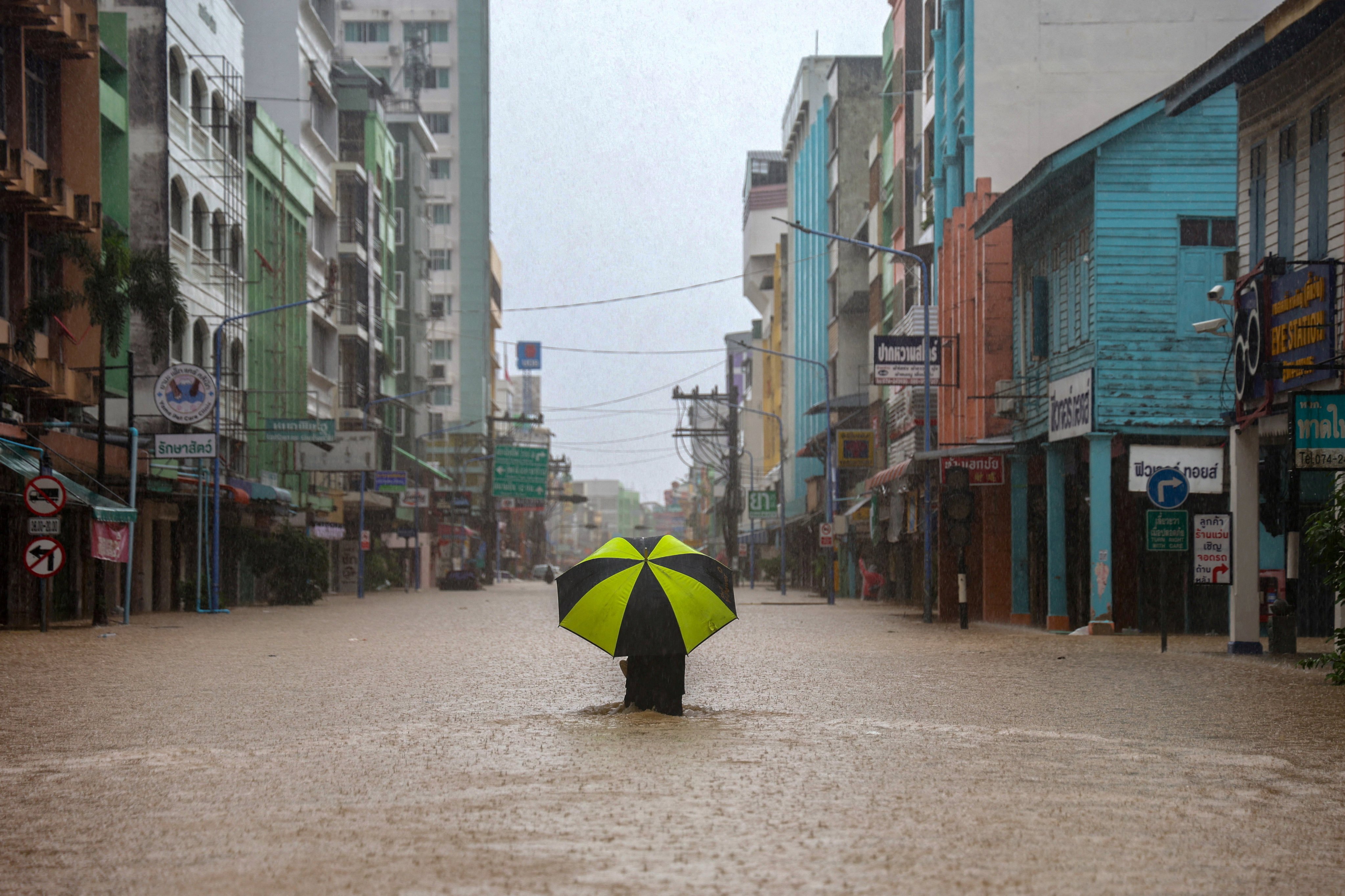 A person wades through a flooded area in Hat Yai, a major southern city in Thailand’s Songkhla province, on Saturday. Hat Yai has been declared a disaster zone. Photo: Reuters