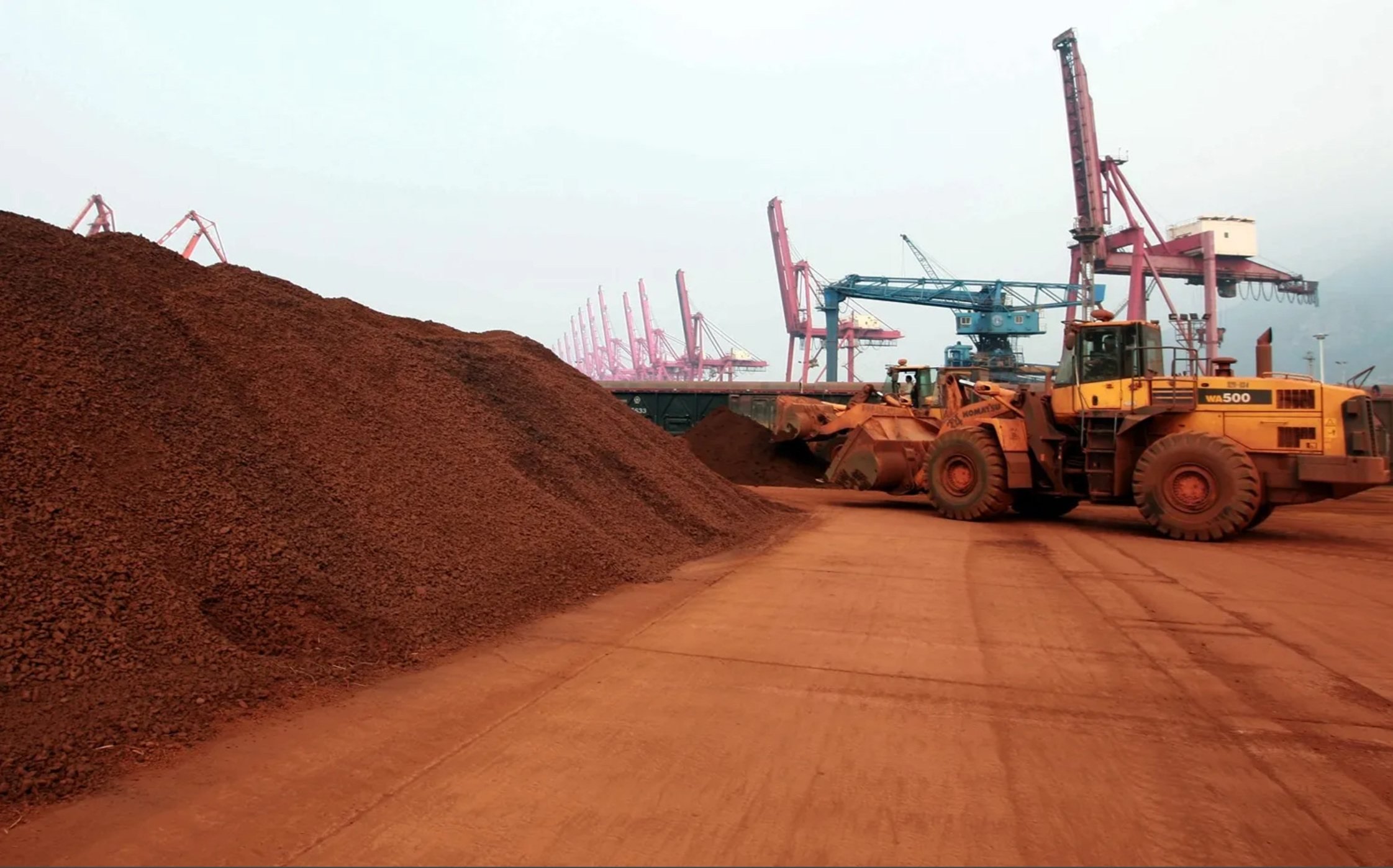 A worker shifts soil containing rare earth minerals to be loaded at a port in China’s Jiangsu province. Photo: AFP