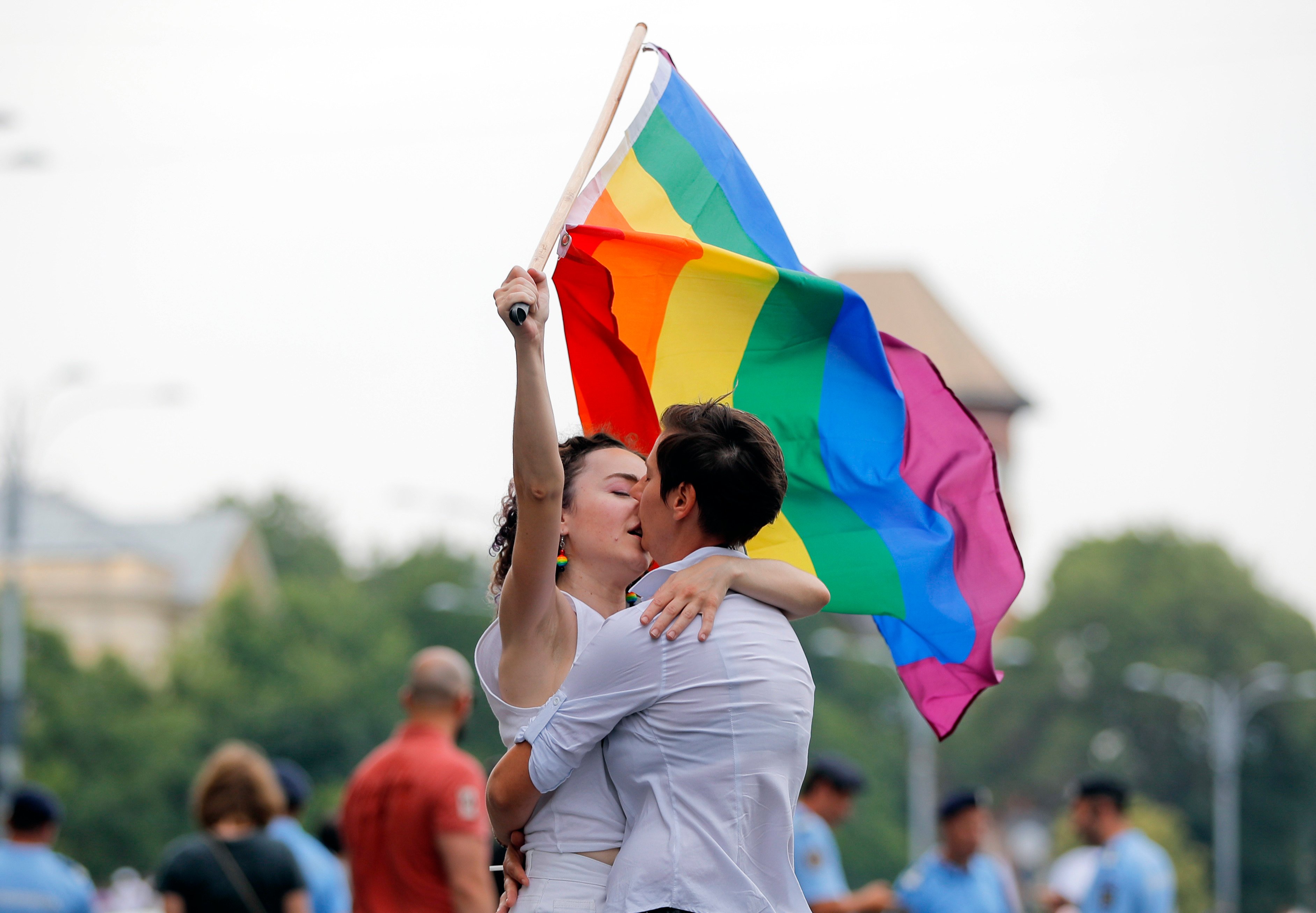 Two girls kiss holding a rainbow flag during the gay pride parade in Bucharest, Romania in 2018. Photo: AP