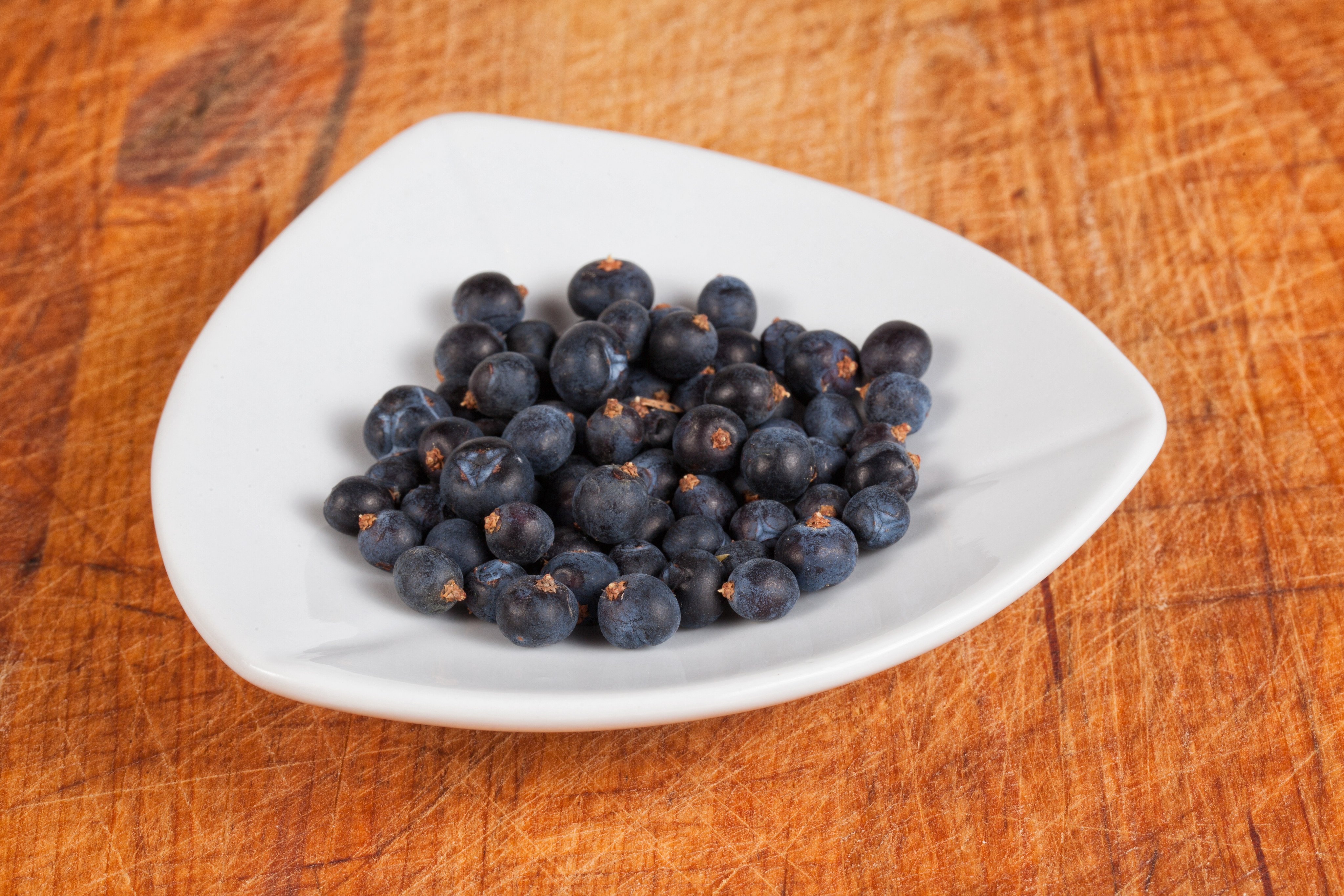 Juniper berries must be cracked or bruised to unleash their sharp, resinous flavour. Use them in marinades for venison and other gamey meats, or to add flavour to sauerkraut. Photo: Shutterstock