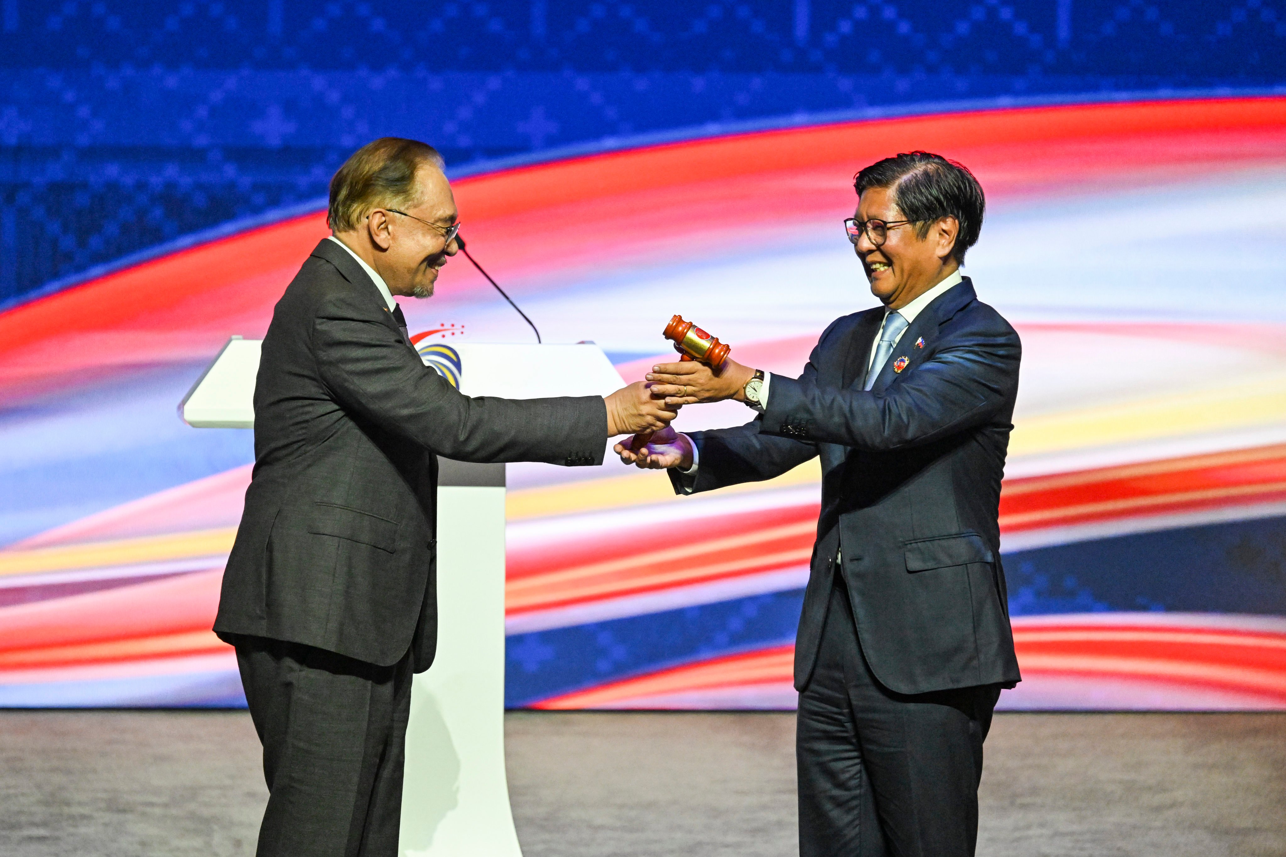 Malaysian Prime Minister Anwar Ibrahim hands the gavel over to Philippine President Ferdinand Marcos Jnr at the closing ceremony of the 47th Asean summit in Kuala Lumpur, Malaysia, on October 28. The Philippines takes over as Asean chair on January 1. Photo: Xinhua