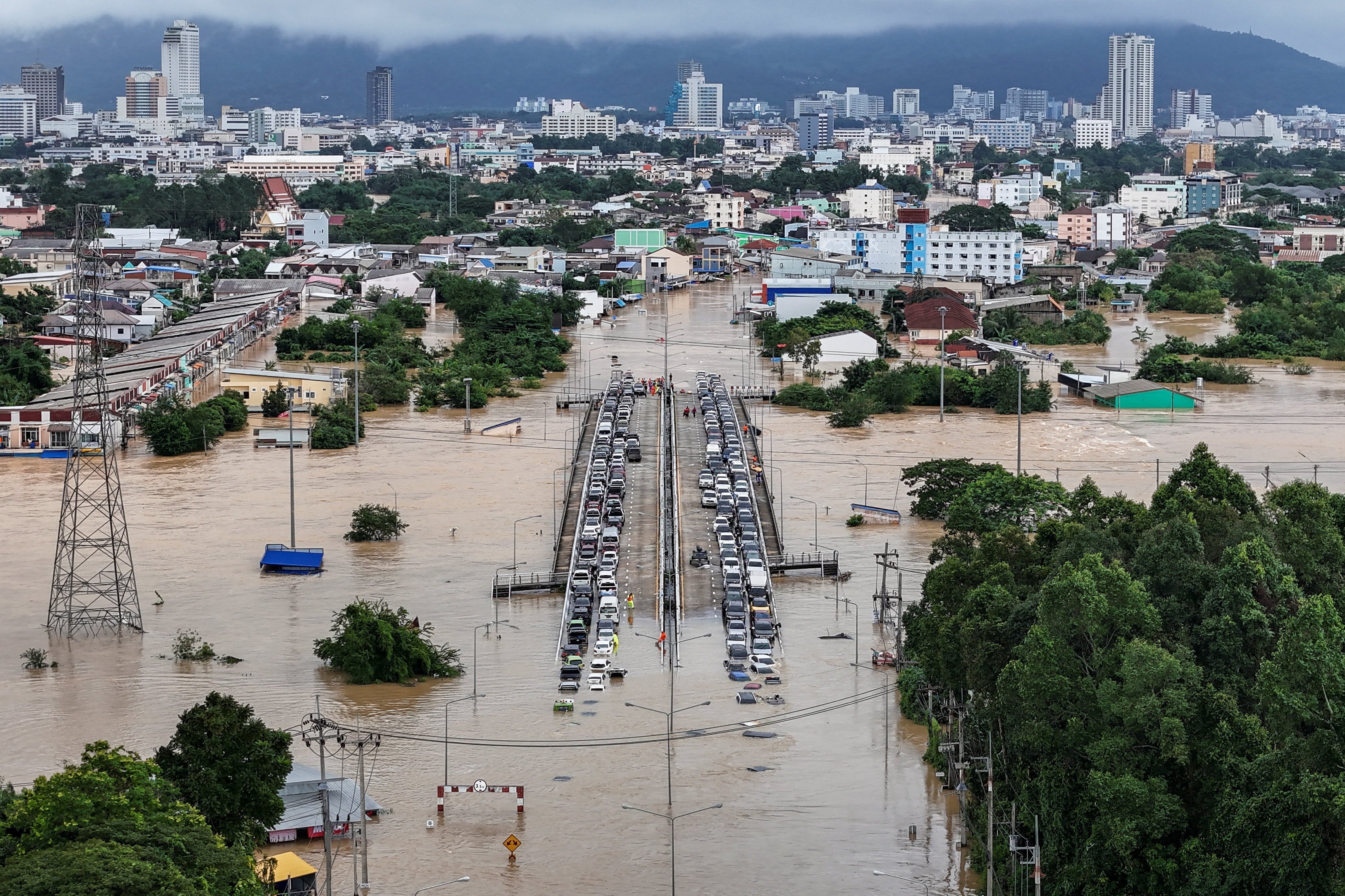 Cars parked on a bridge to escape floodwaters in Hat Yai on Tuesday. Photo: Reuters