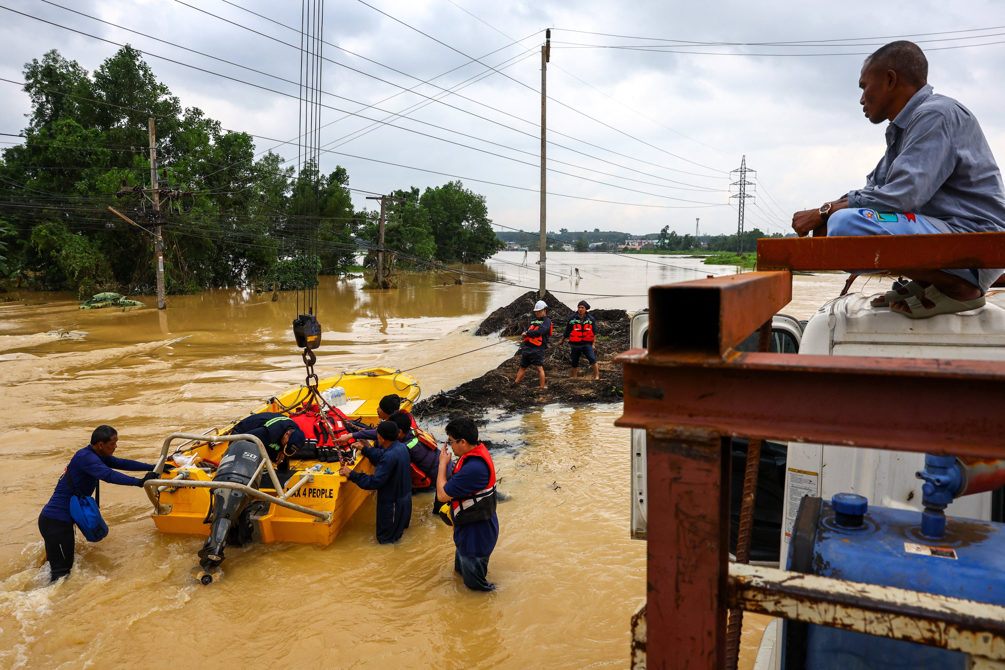 Volunteers launch a boat in a flooded area in Hat Yai, Thailand on Thursday. Photo: Reuters