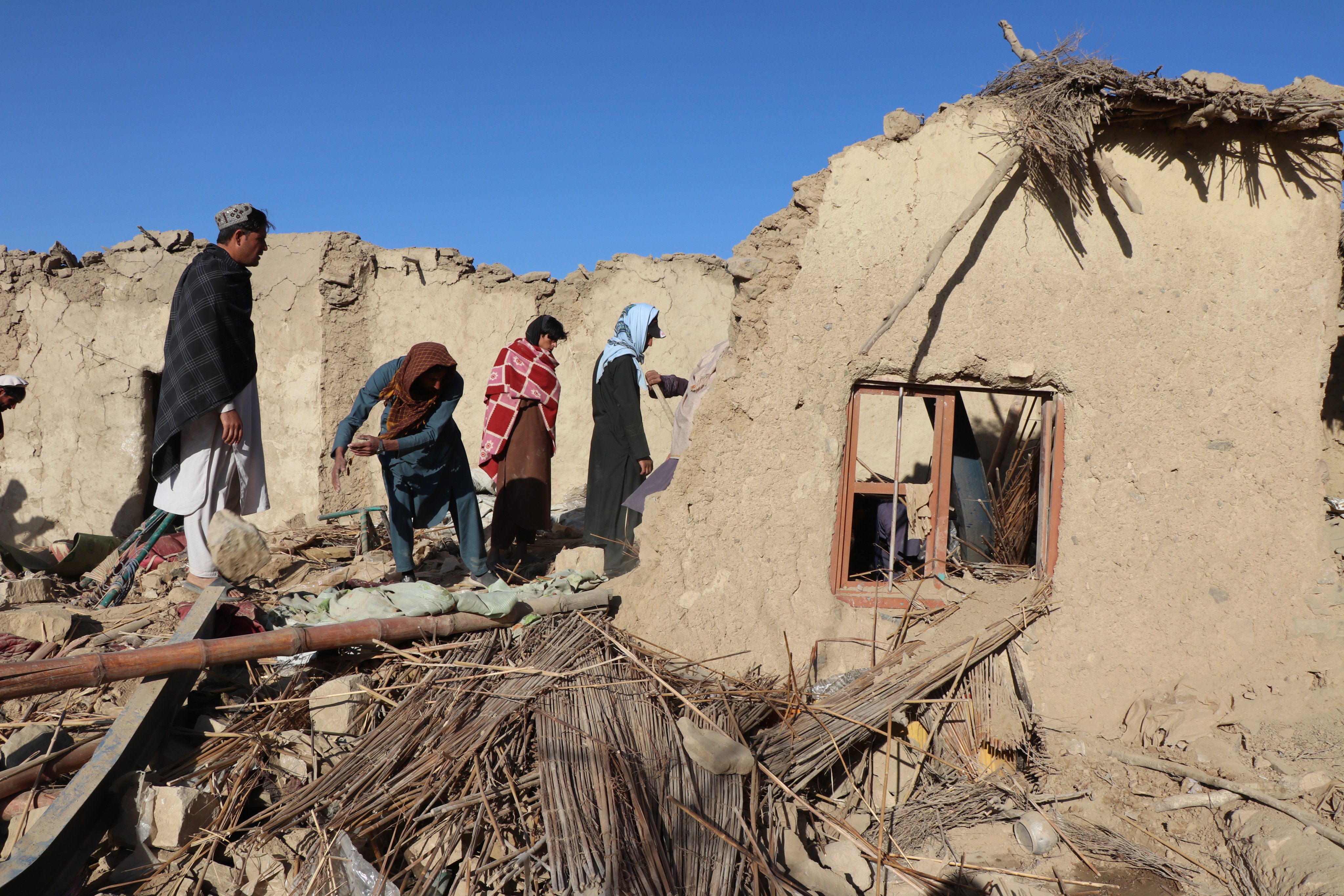 Residents clear debris from houses destroyed in air strikes in Khost, Afghanistan, on Tuesday. Photo: EPA