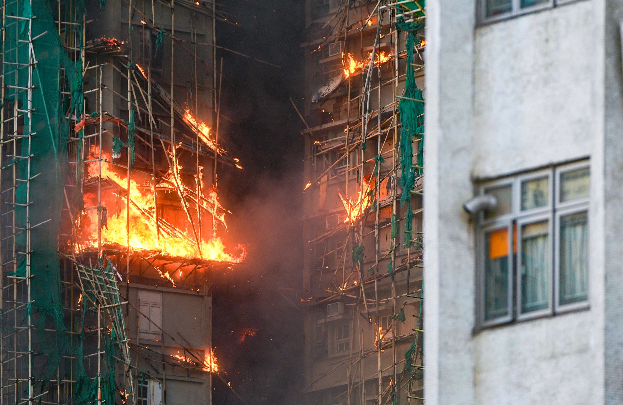 The fire resistance level of the scaffolding on the buildings has come under immediate scrutiny. Photo: Eugene Lee