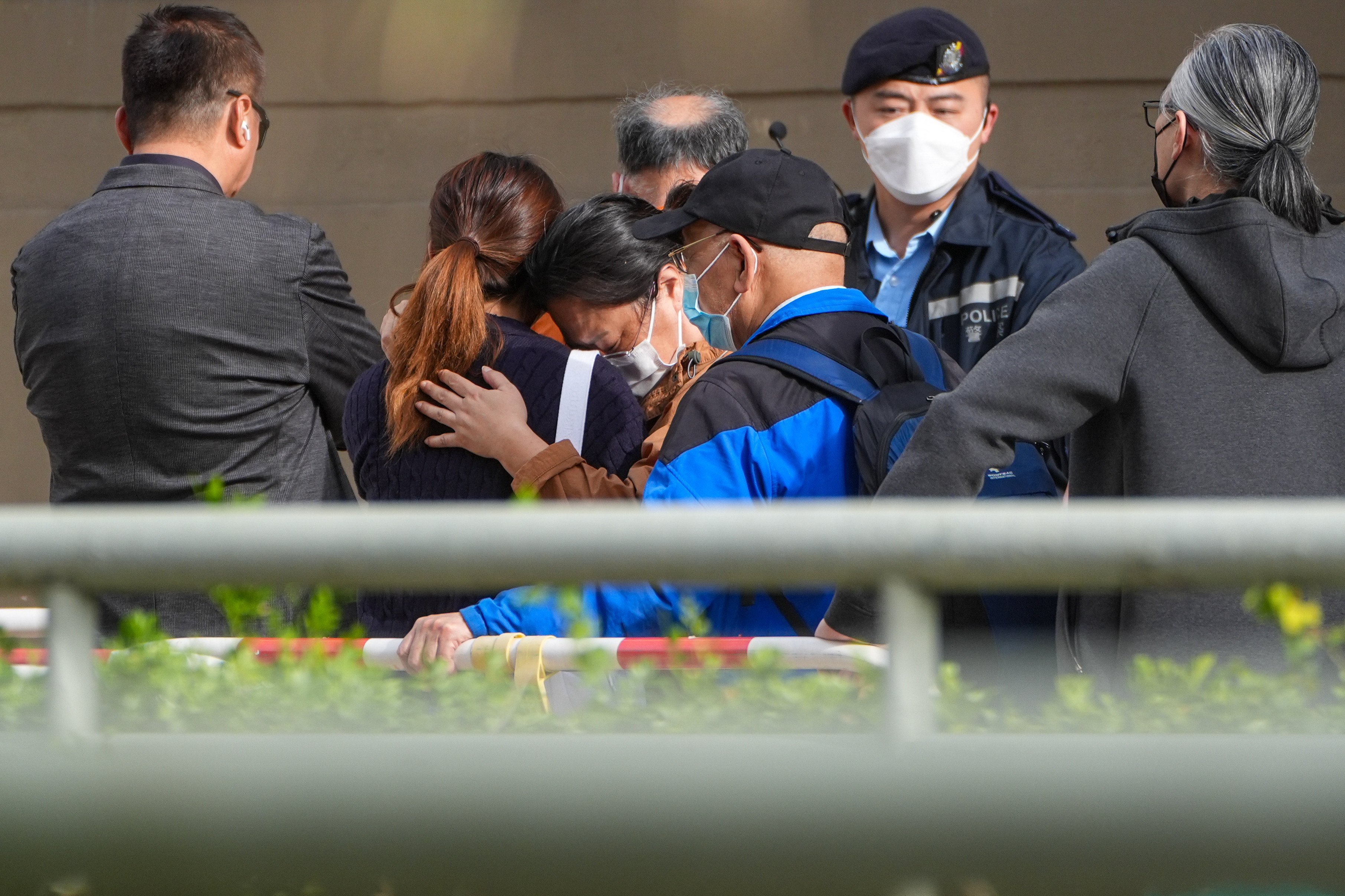 People console each other after identifying deceased relatives at Kwong Fuk Community Hall following the fatal fire at Wang Fuk Court in Tai Po, on November 27. Photo: Eugene Lee
