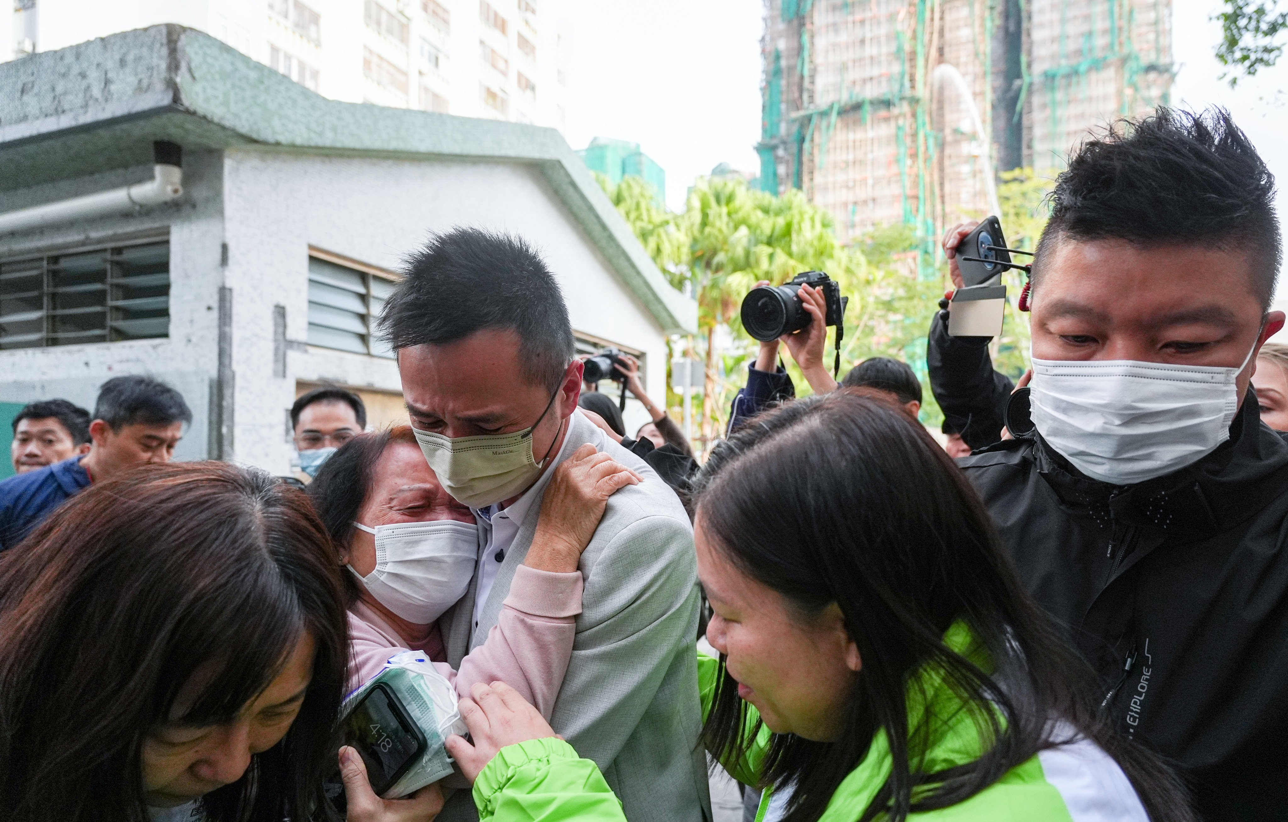 People weep after identifying their deceased relatives at Kwong Fuk Community Hall. Photo: Eugene Lee