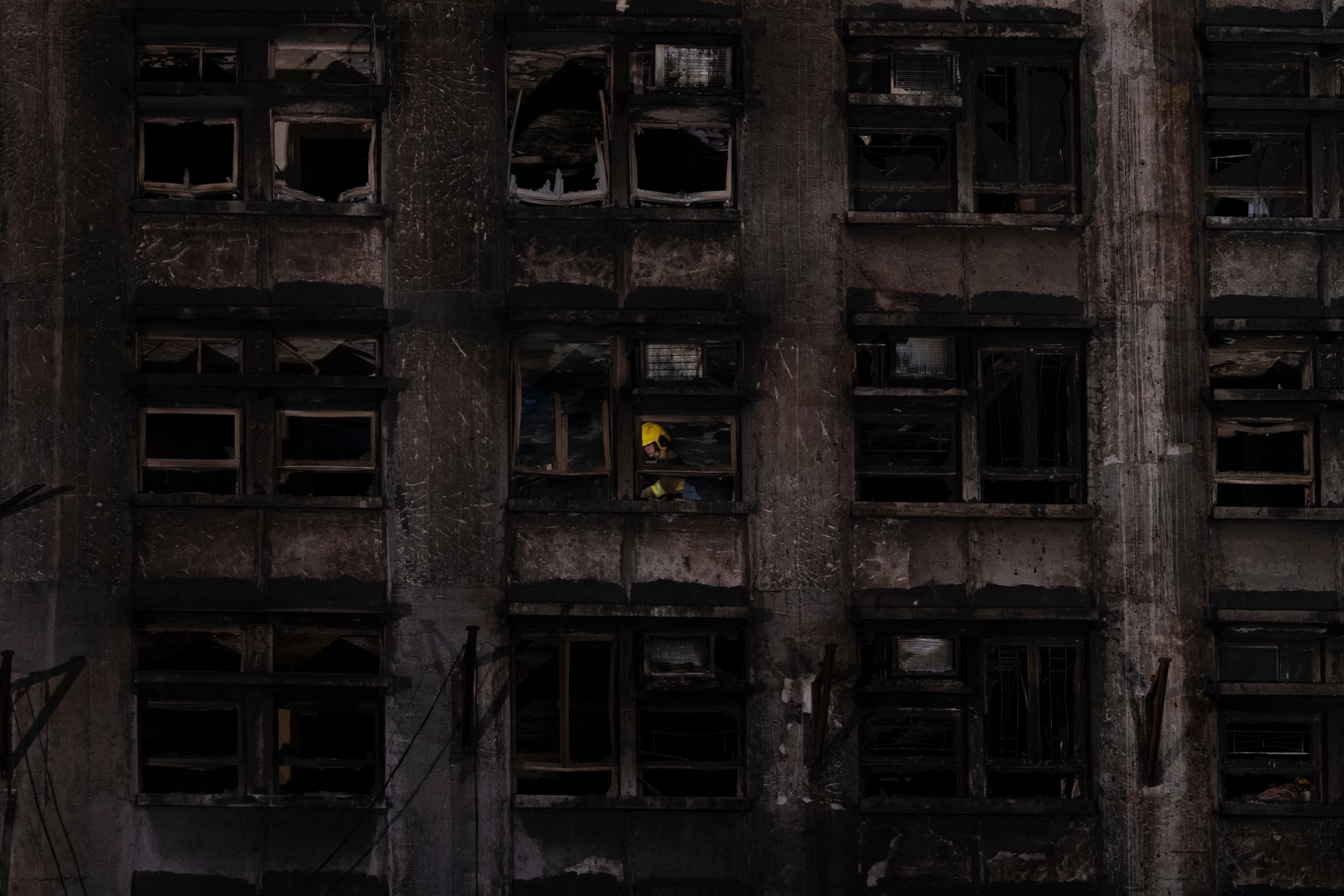 A firefighter searches through a building in the aftermath of the fire at Wang Fuk Court. The heroic efforts of Hong Kong’s firefighters and emergency services must be acknowledged. Photo: AP