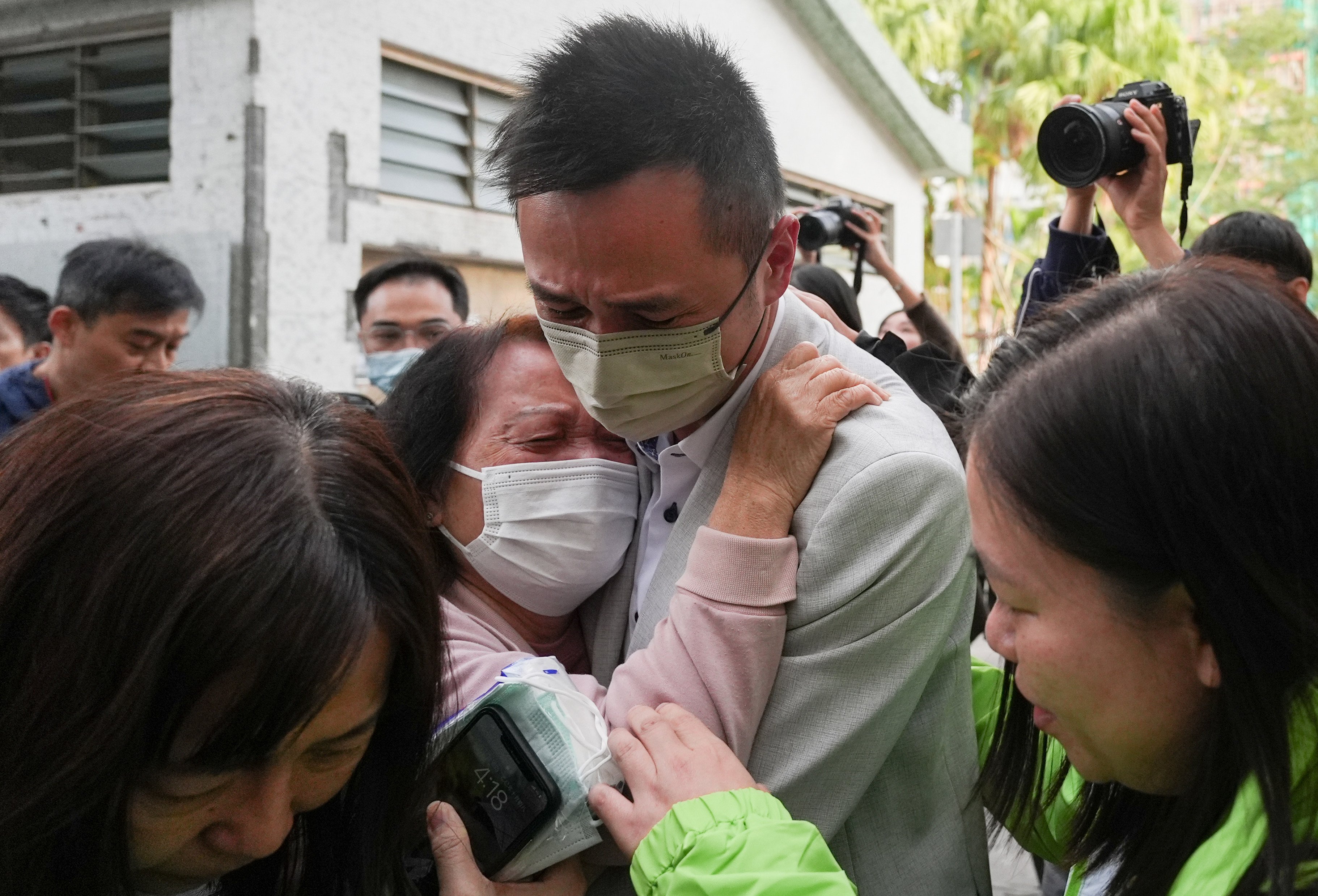 Relatives weep after identifying loved ones who perished in the fire. Photo: Eugene Lee