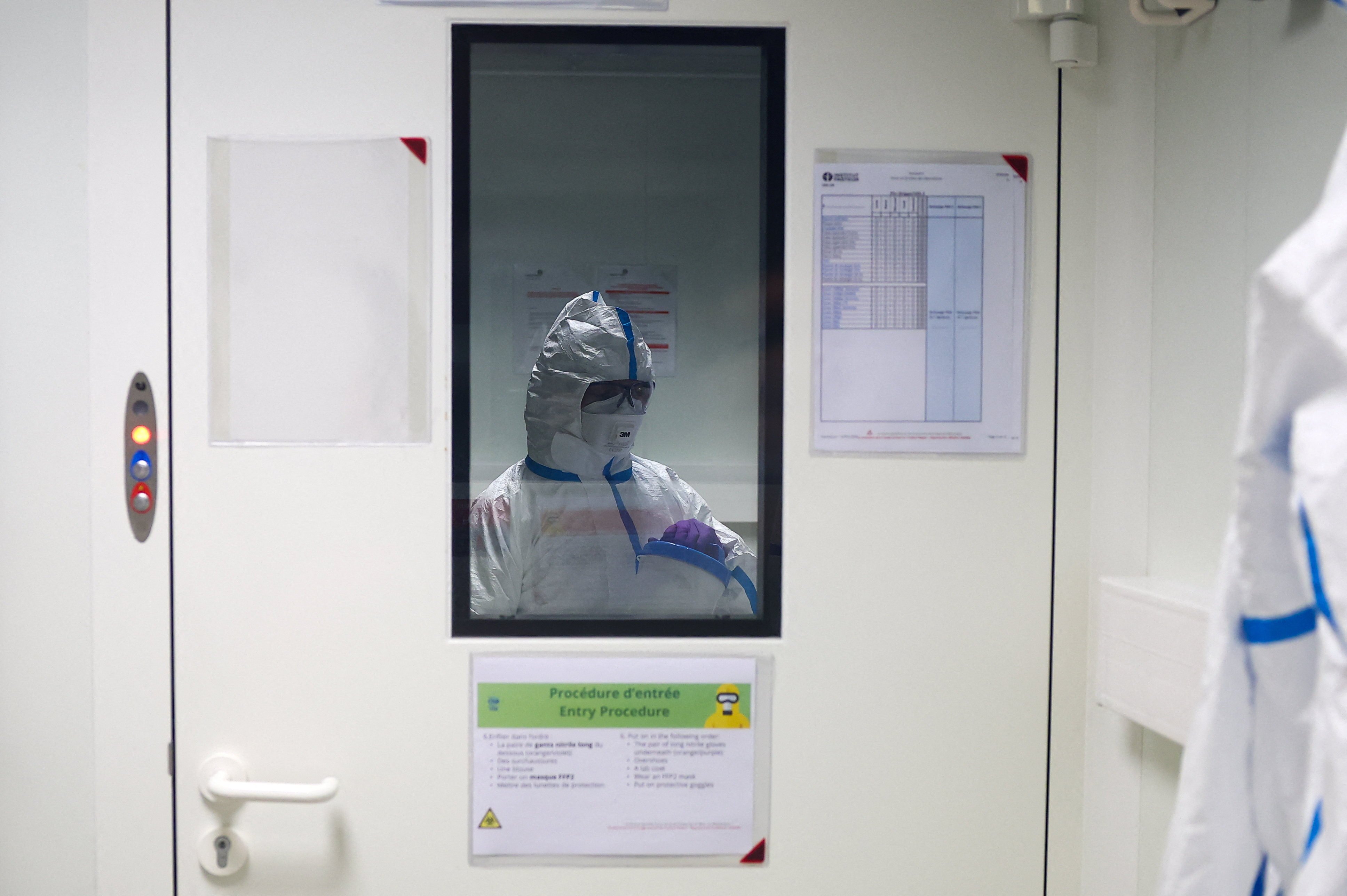 A researcher wearing a protective suit at the Institut Pasteur in Paris, where scientists work to monitor and prevent the spread of avian influenza. Photo: Reuters
