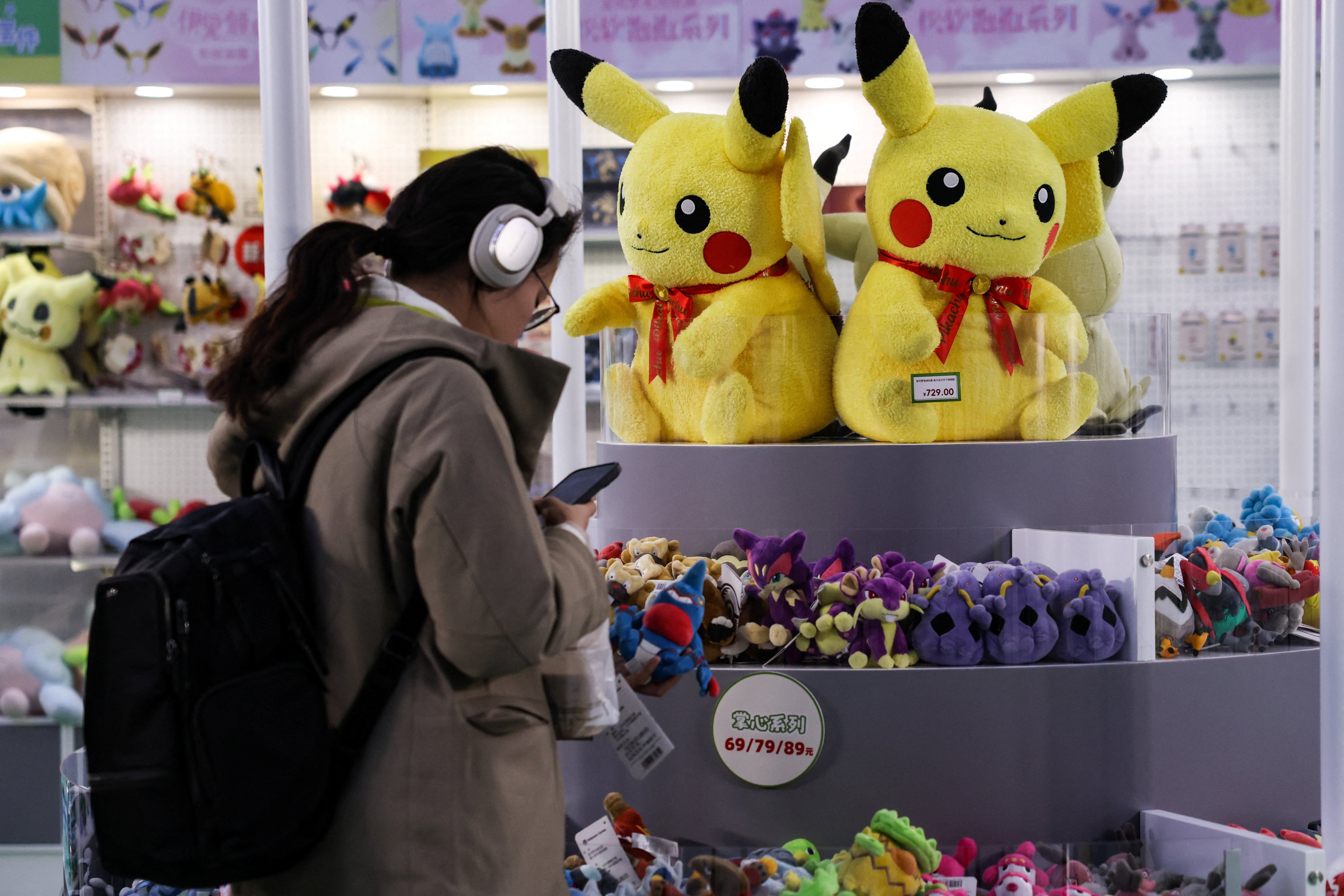 A customer at a Pokemon pop-up store, featuring toys based on the Japanese animated series, in a Beijing shopping centre on November 18. Photo: Reuters