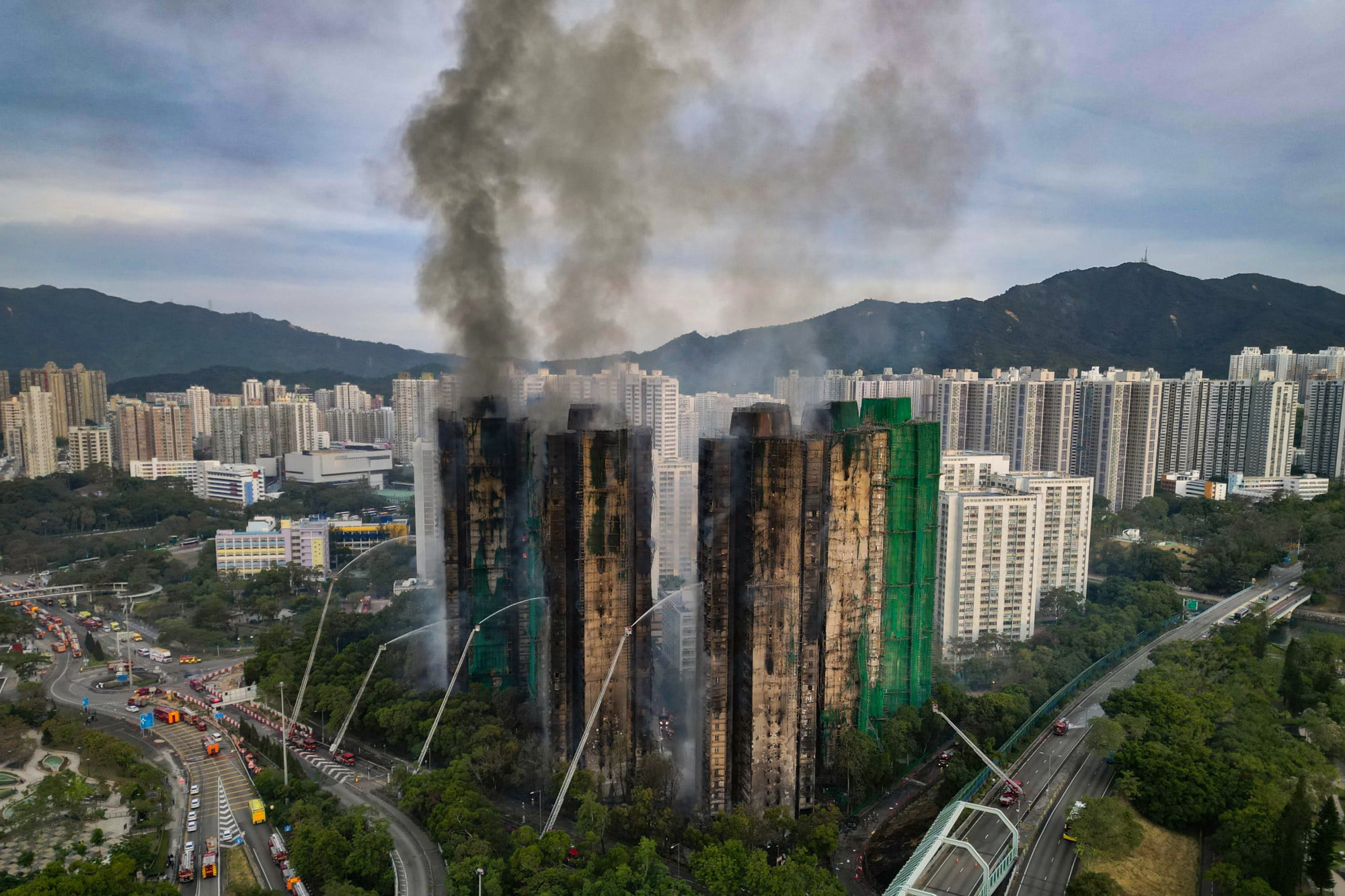 Smoke rises from blocks at Wang Fuk Court. Photo: Karma Lo