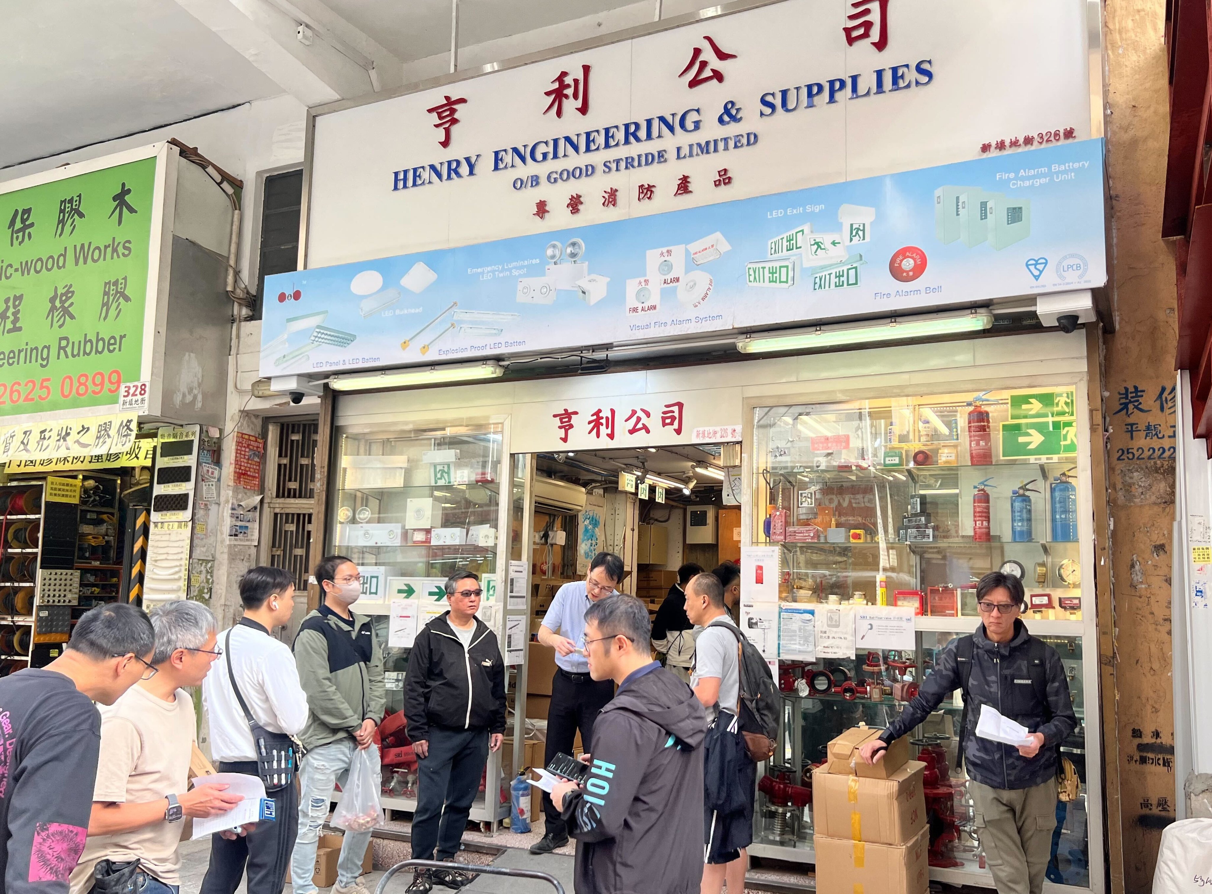 Customers queue outside a fire safety shop in Yau Ma Tei. Photo: Zhao Ziwen