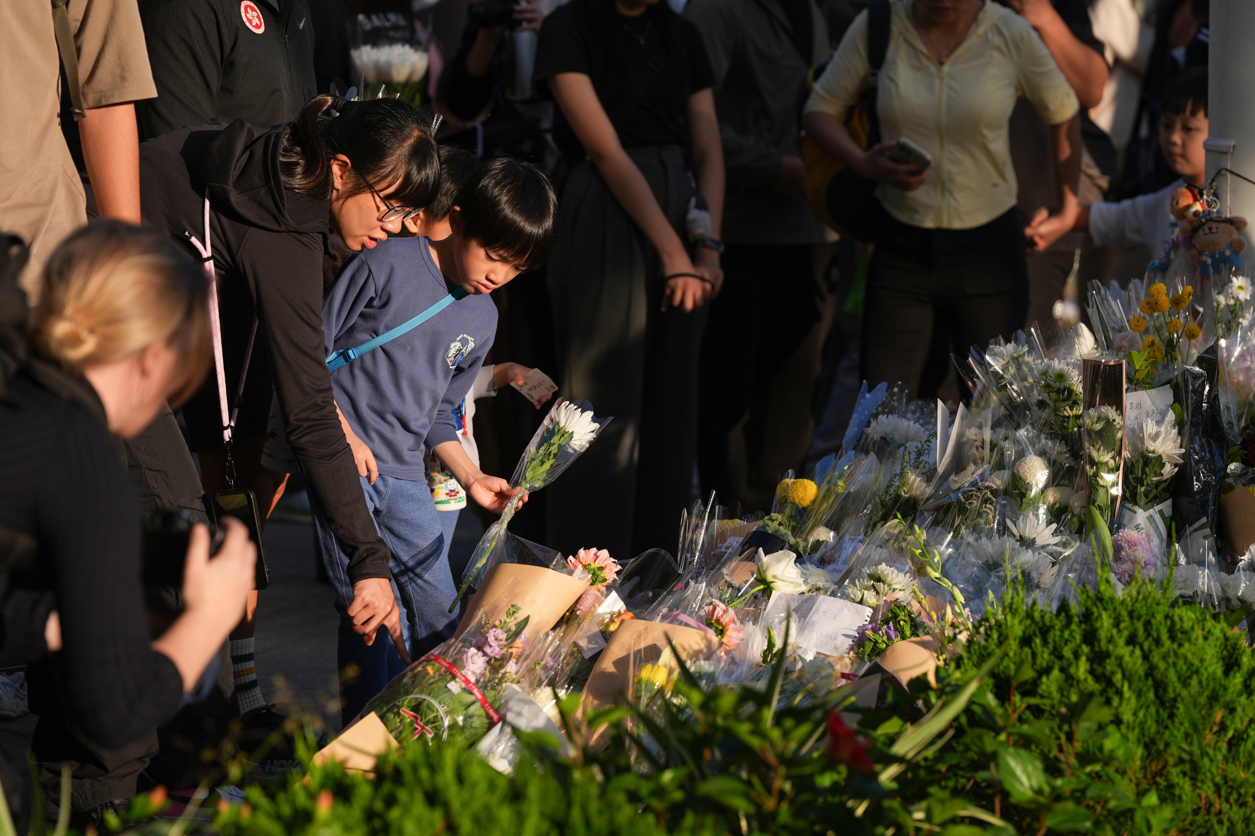 People leave flowers as Hongkongers mourn the fire victims. Photo: Eugene Lee