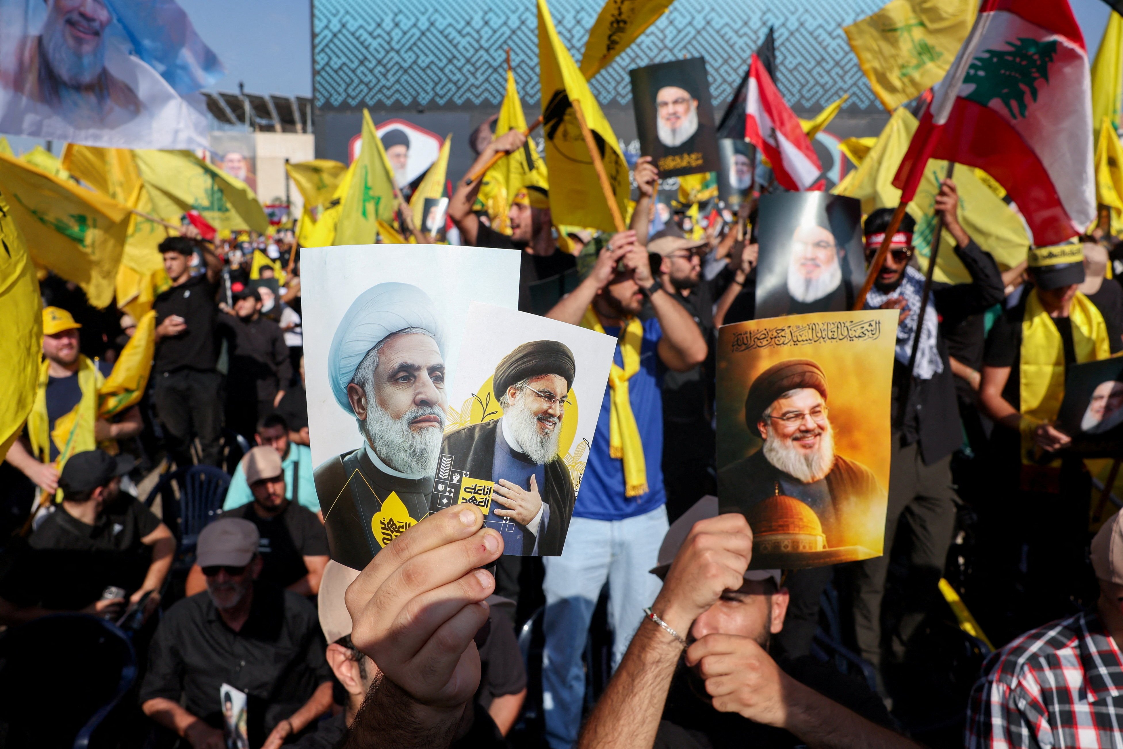 Hezbollah supporters hold images of late leader Hassan Nasrallah and current leader Naim Qassem on the outskirts of Beirut, Lebanon, in September. Photo: Reuters