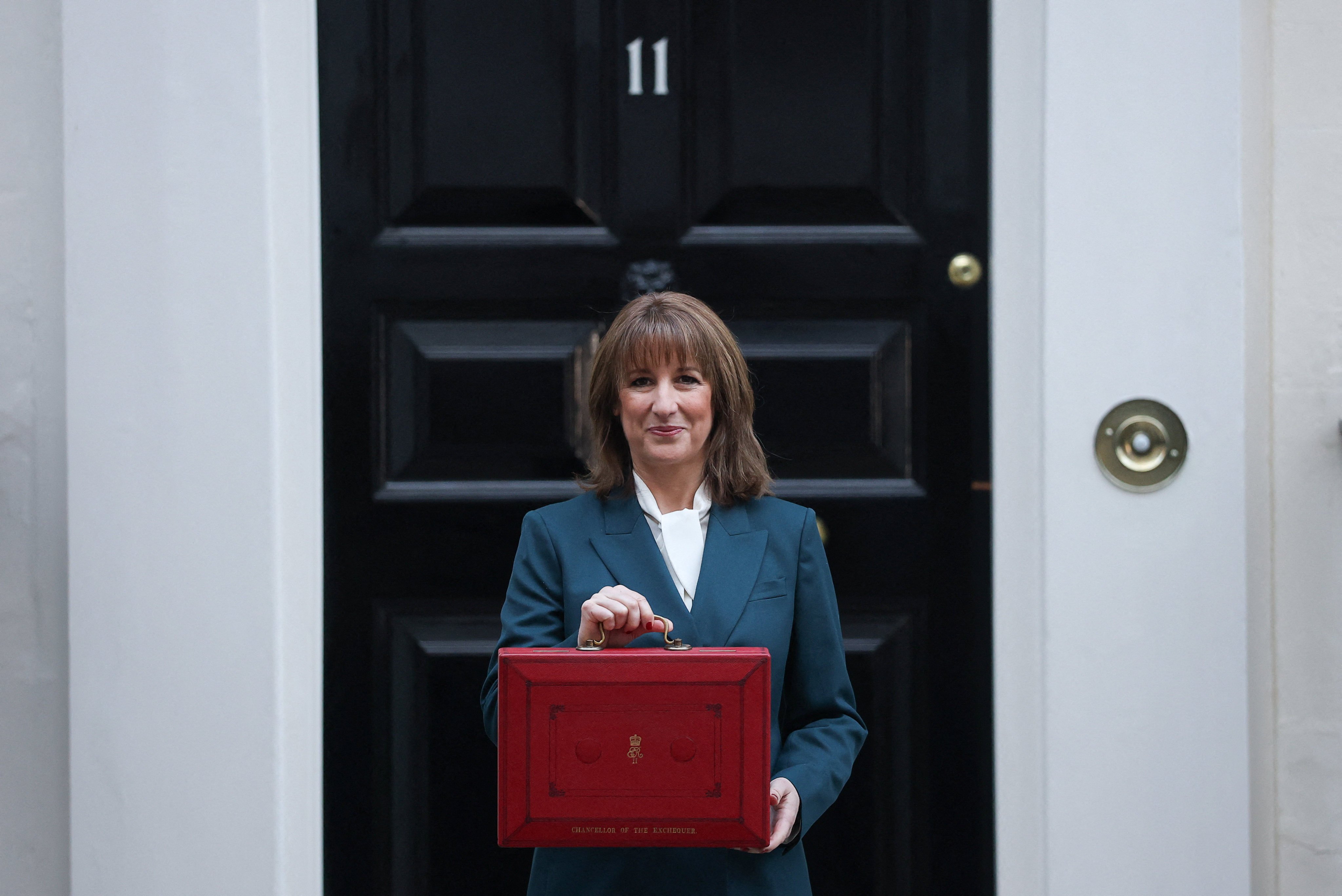 Britain’s Chancellor of the Exchequer Rachel Reeves poses with her ministerial red box before heading to the House of Commons to deliver her budget speech on November 26. Photo: Reuters