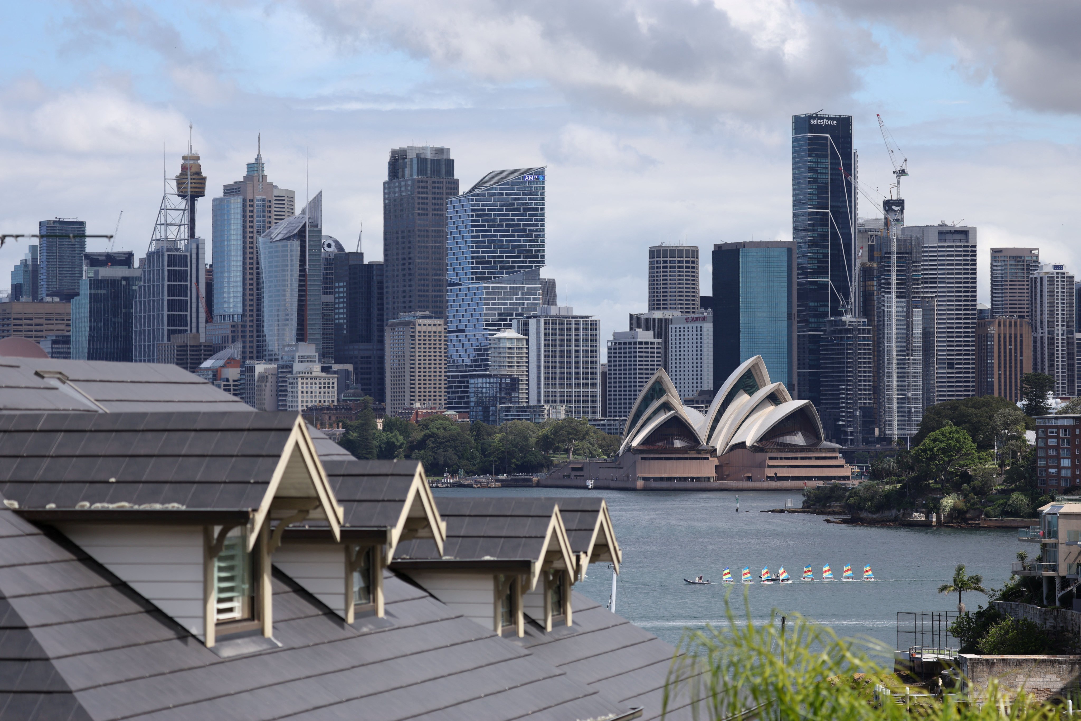 The Sydney skyline is seen from a suburb. Four men have been arrested in the city for possessing “satanic” child abuse material. Photo: Reuters