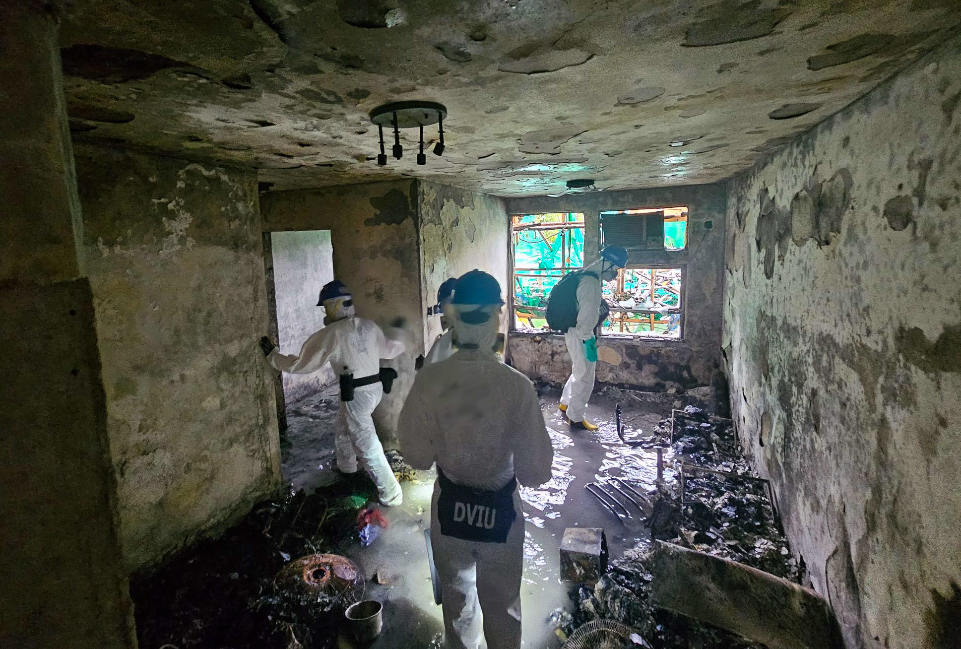 Members of the Disaster Victim Identification Unit   search one of the burned buildings at Wang Fuk Court in Tai Po. Photo: handout