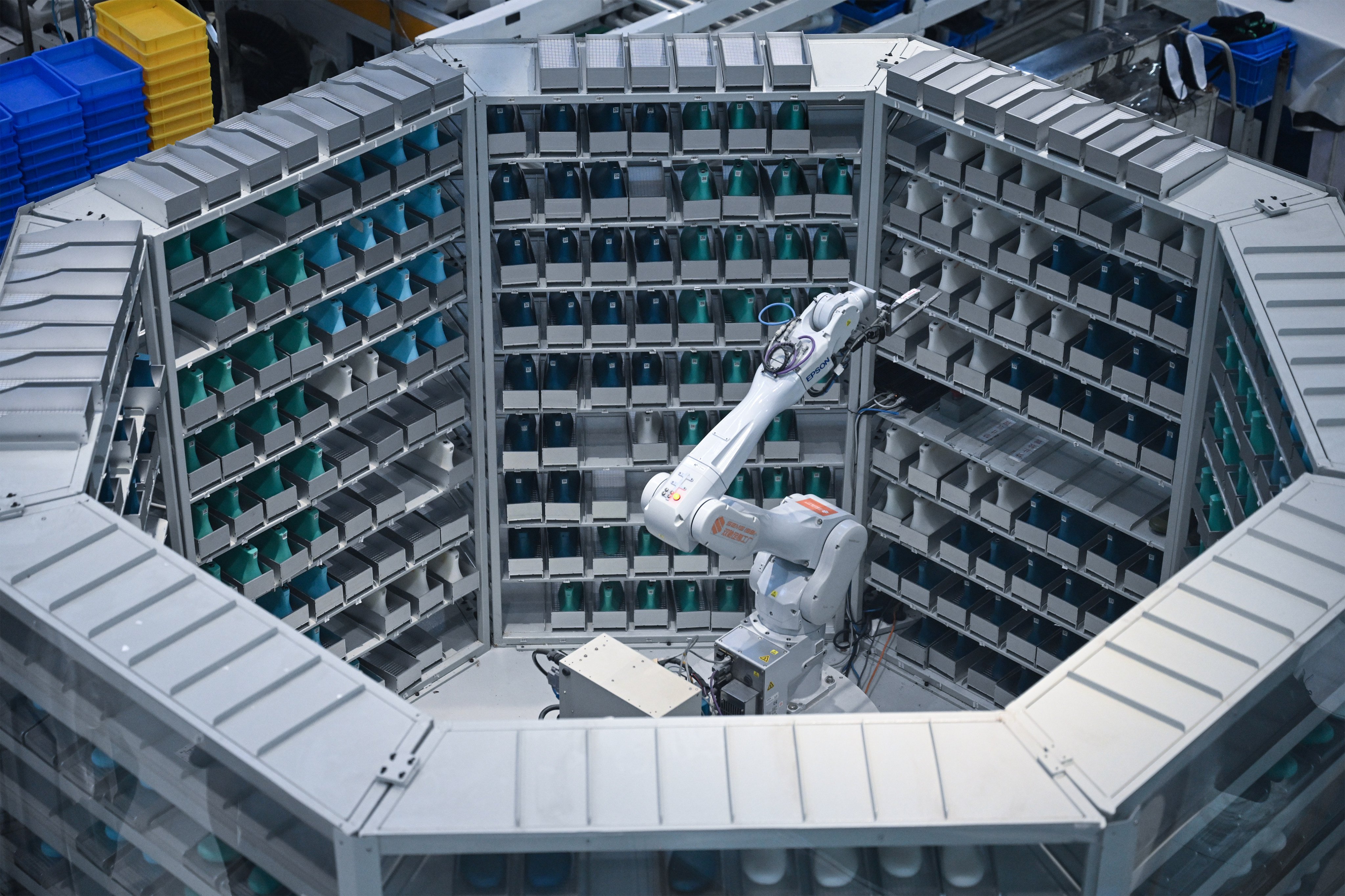 A robotic arm moves stock at the smart workshop of a footwear company in China’s southeastern Fujian province. Photo: Xinhua