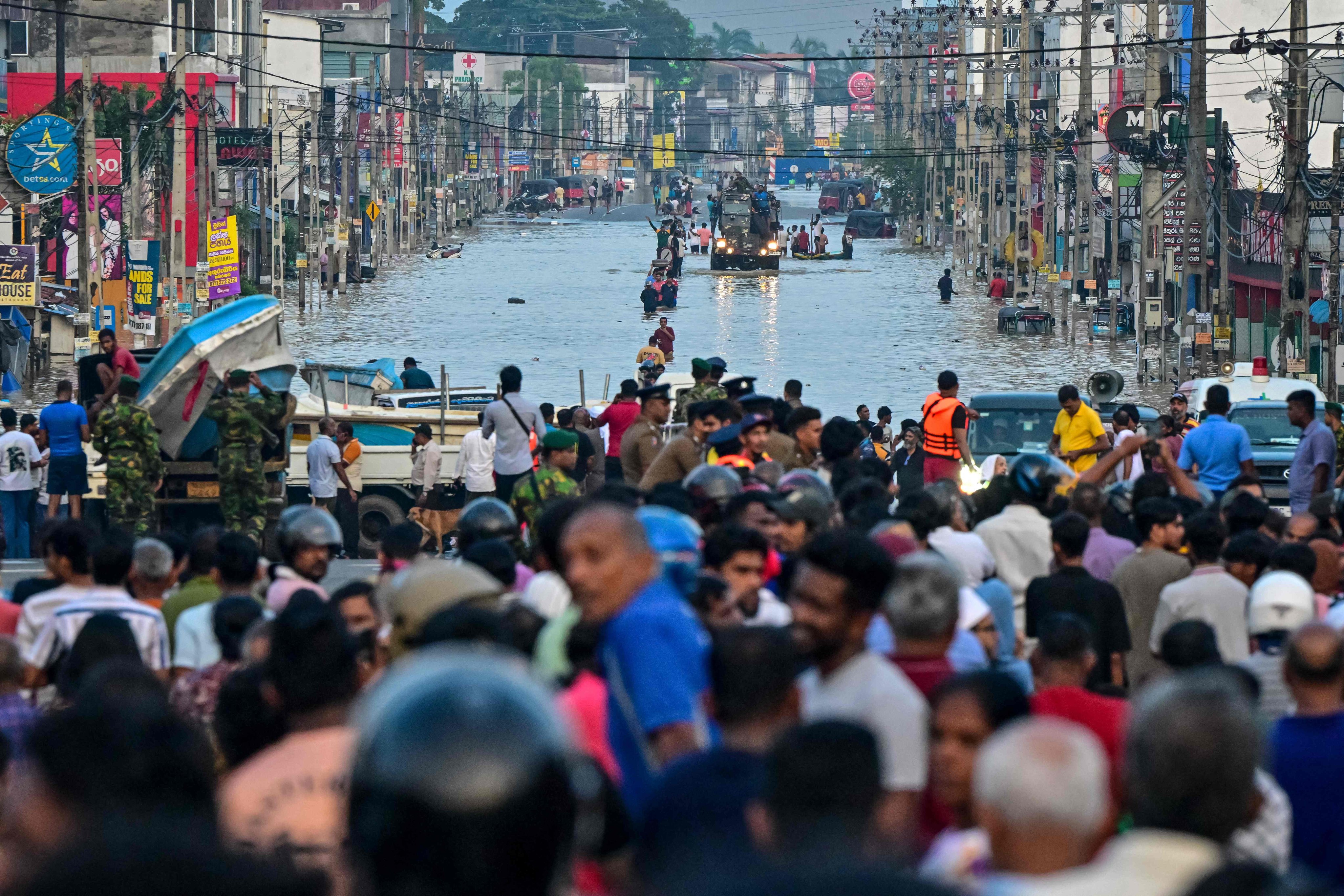 Army personnel ride a truck carrying boats to rescue stranded people in Wellampitiya, on the outskirts of Colombo, Sri Lanka on Sunday. Photo: AFP