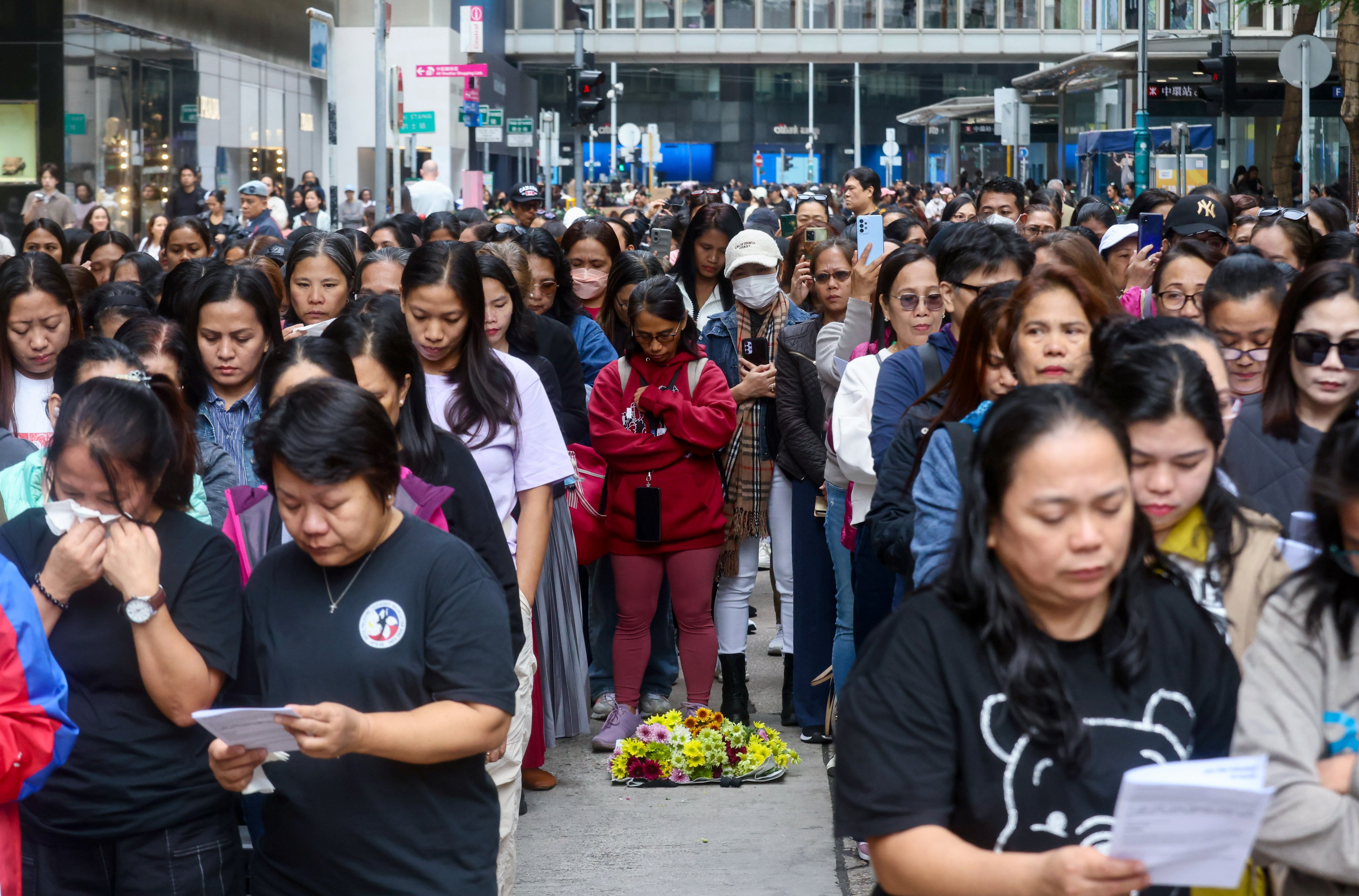 Helpers mourn those killed in the deadly Tai Po fire. Photo: Jonathan Wong