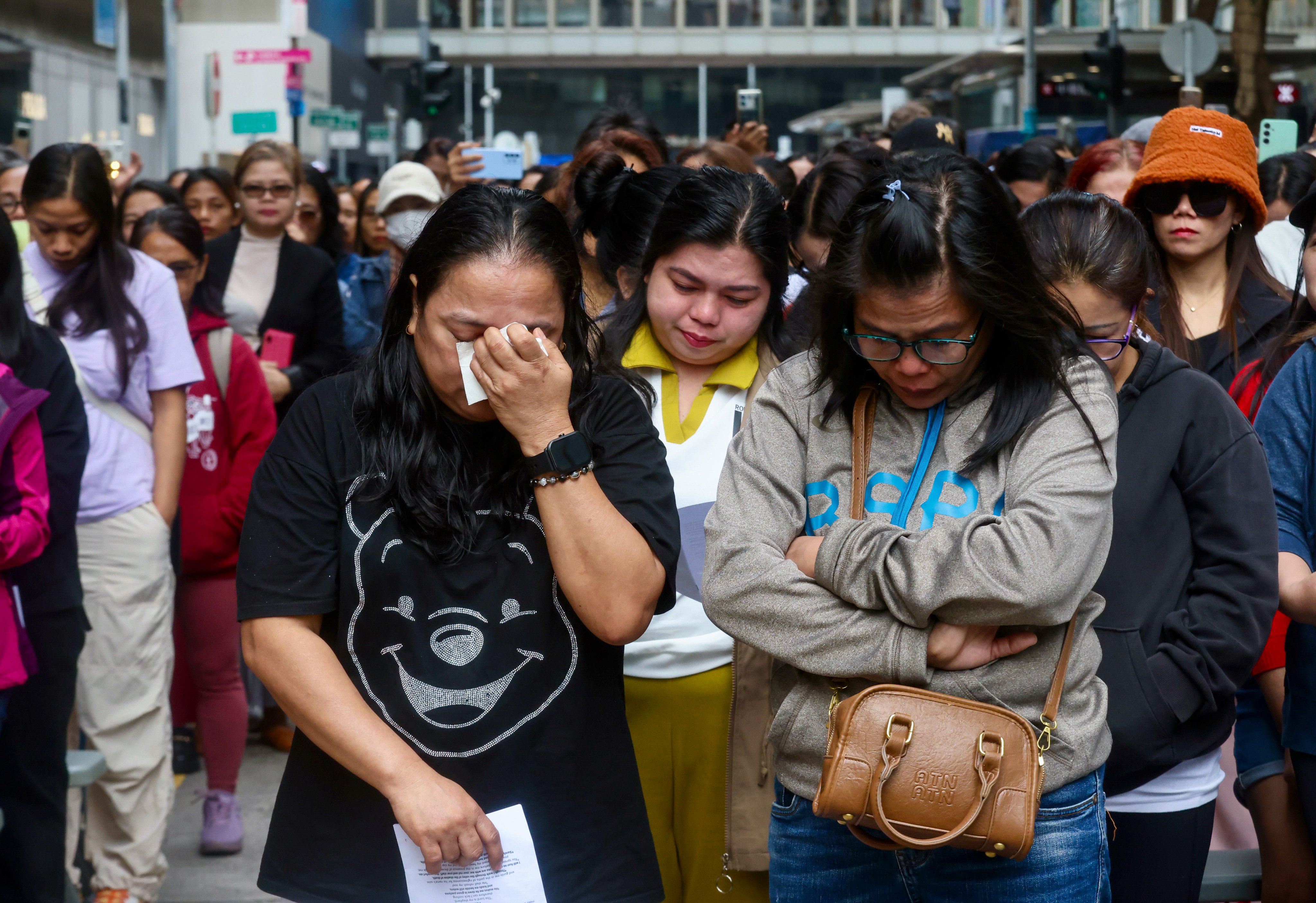 Domestic helpers mourn victims of the Tai Po fire at a prayer gathering in Central. Photo: Jonathan Wong