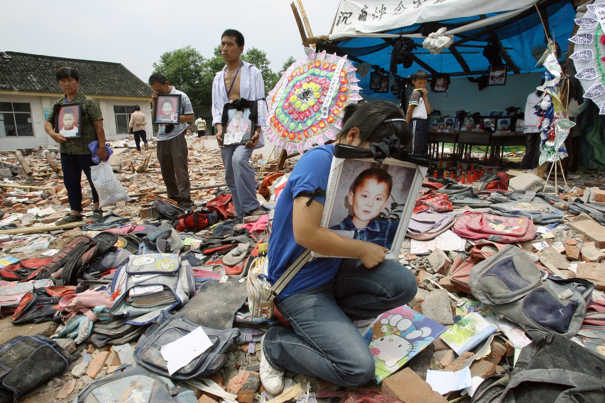 Crying parents hold pictures of their children in the aftermath of the 2008 Wenchuan earthquake, which left more than 200 students dead and injured. Photo: Robert Ng Crying parents hold pictures of their children in the aftermath of the 2008 Wenchuan earthquake, which left more than 200 students dead and injured. Photo: Robert Ng