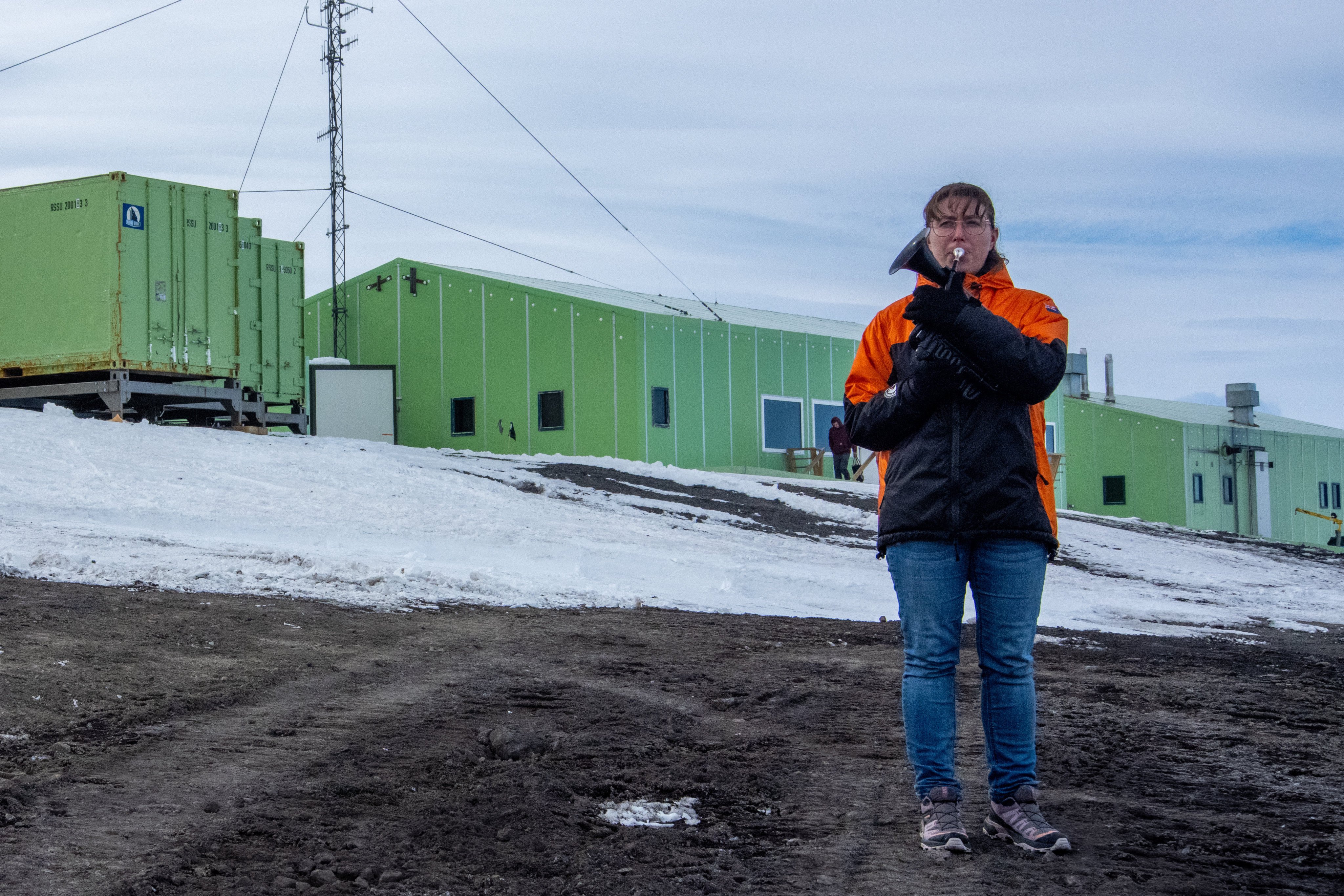 Natalie Paine plays a plastic French horn at Scott Base in Antarctica. Photo: Antarctica New Zealand via AP