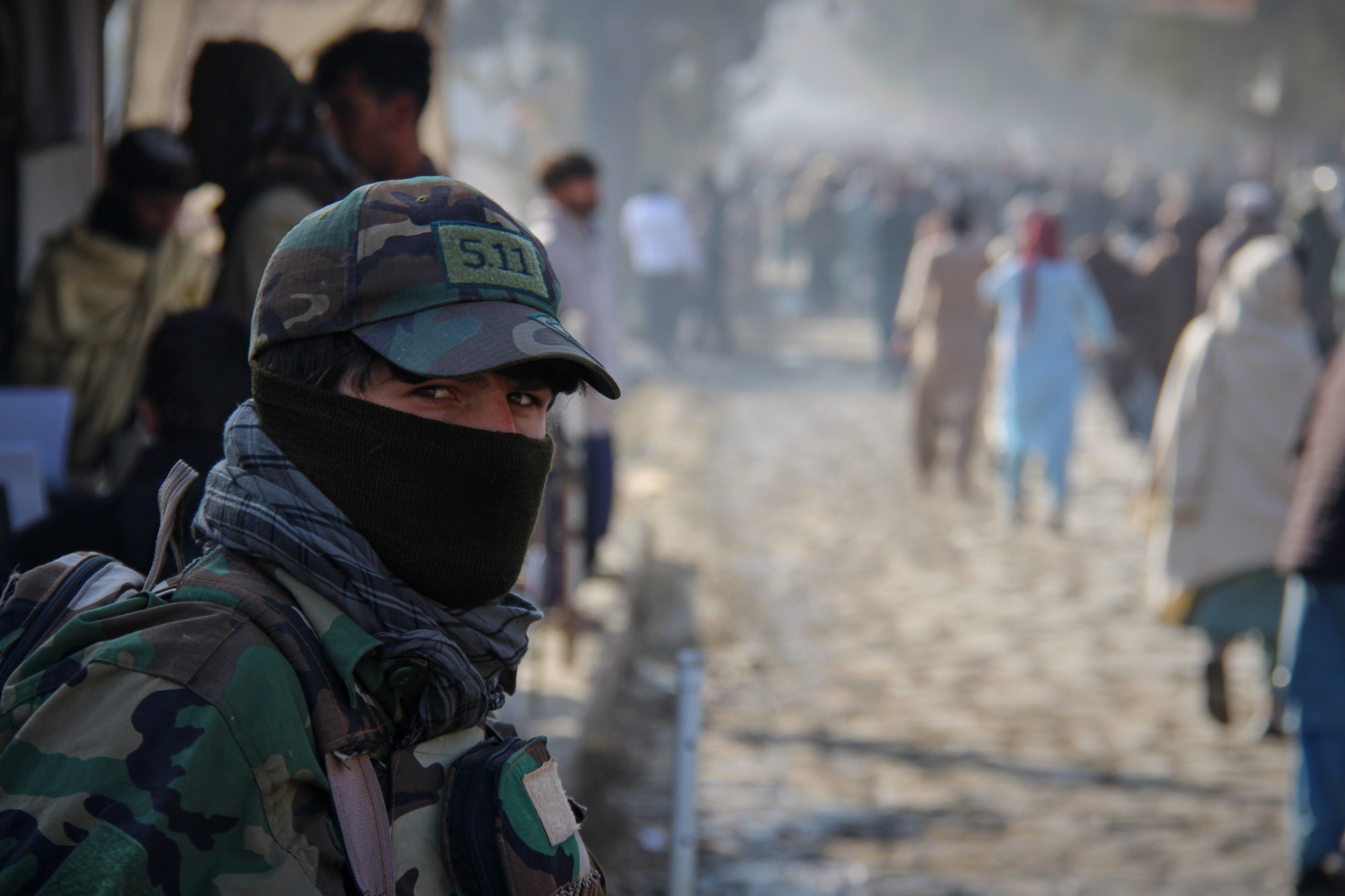 A Taliban policeman looks on as a crowd heads toward a stadium to attend the public execution on Tuesday. Photo: AP