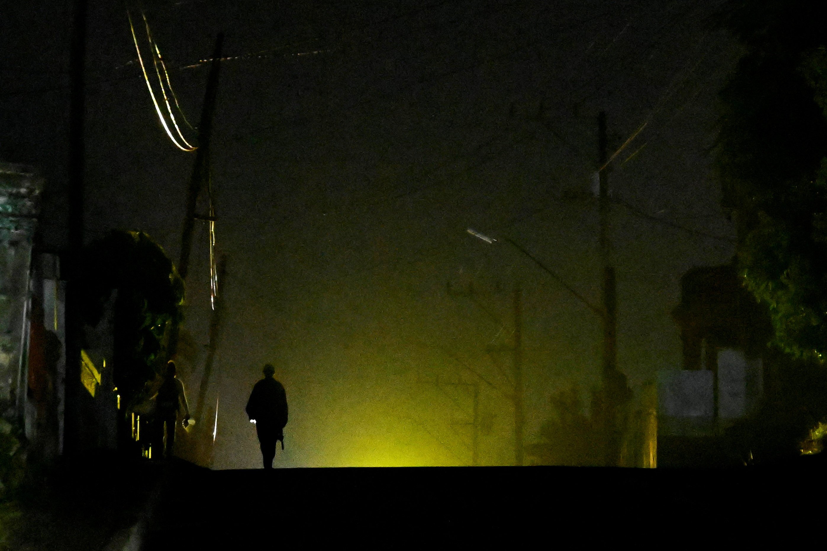 A man walks on the street during a blackout in Havana, Cuba, last month. Photo: Reuters