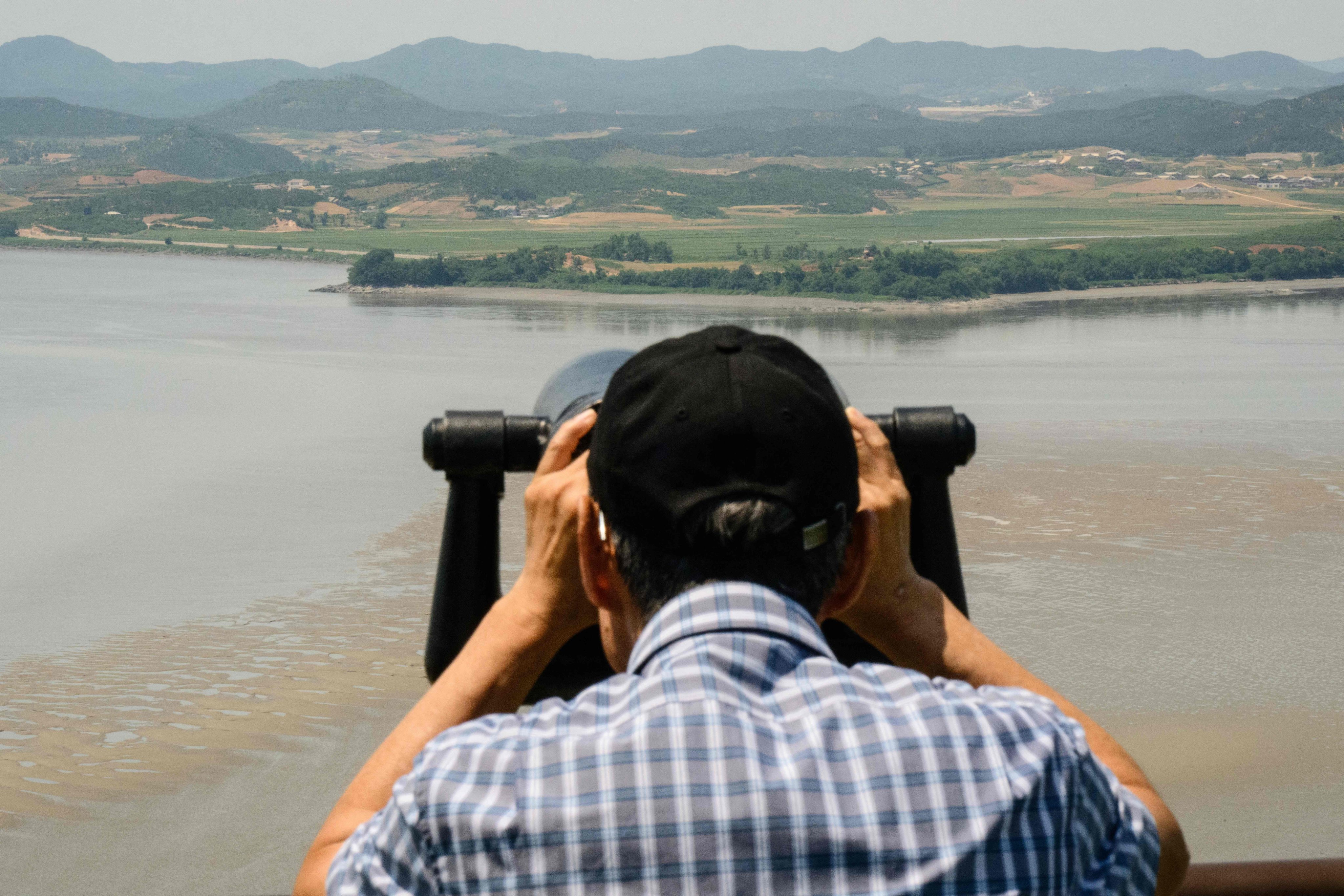 A visitor uses binoculars to watch the North Korean side of the demilitarised zone dividing the two Koreas, from South Korea’s Odusan Unification Observatory in Paju in June. Photo: AFP