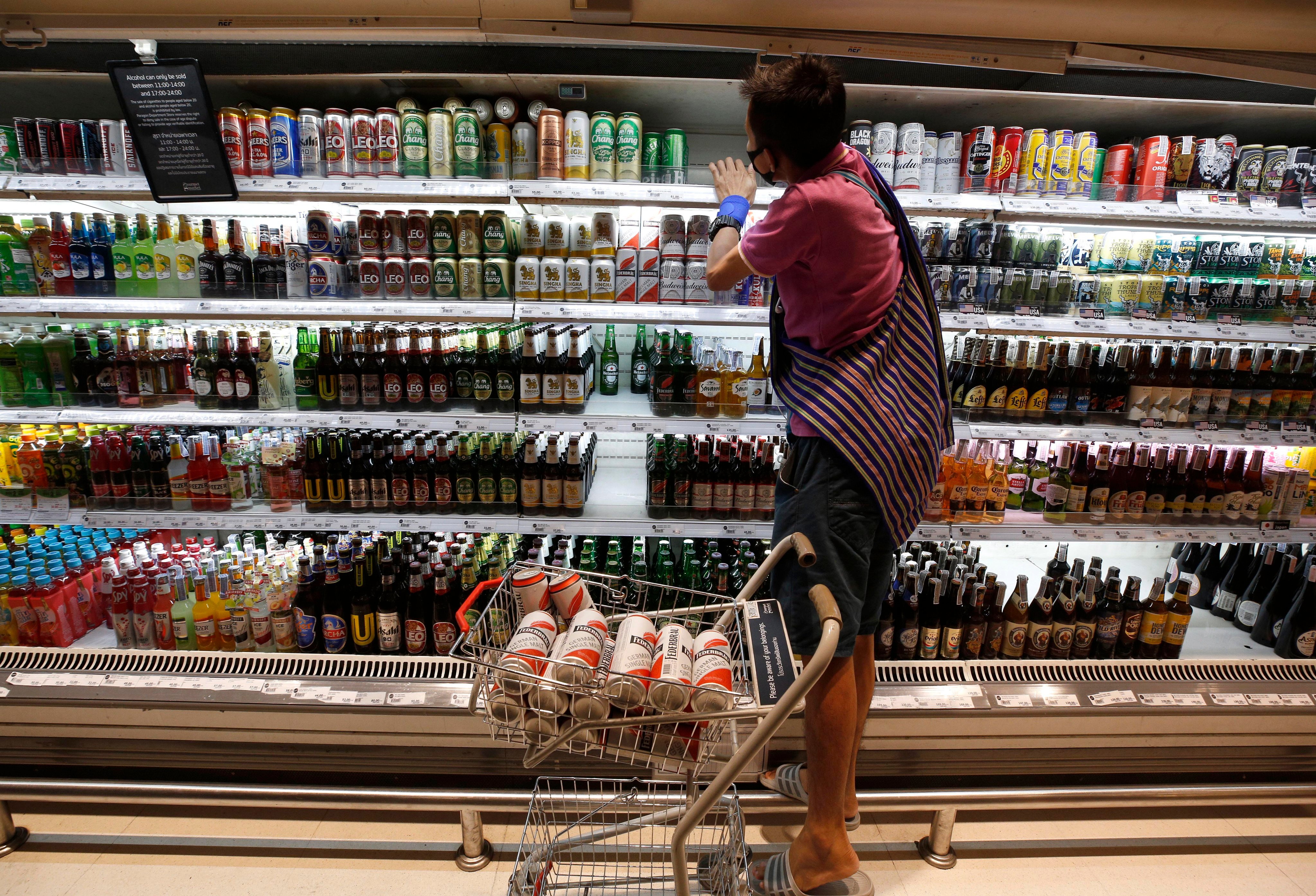 A customer shops for alcoholic beverages at a grocery store in Bangkok. Photo: EPA-EFE