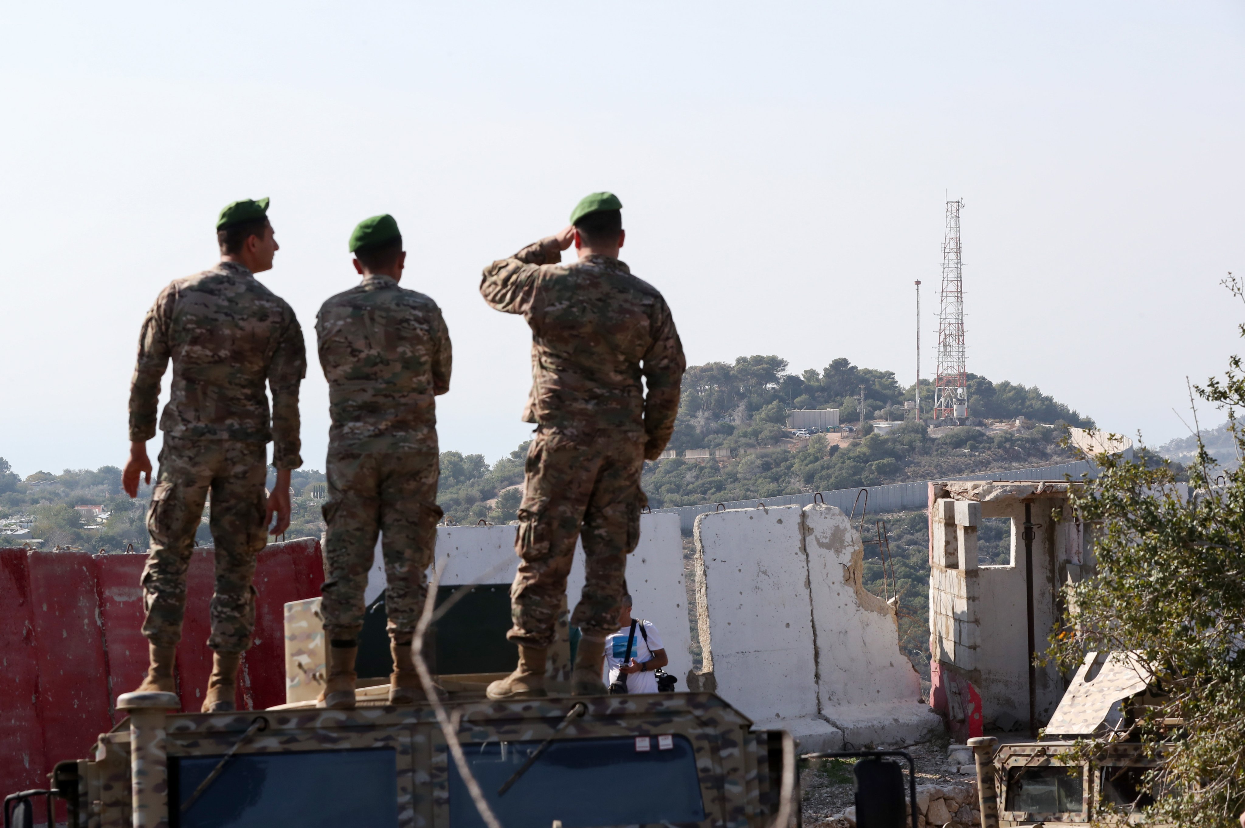 Lebanese army soldiers stand atop a military vehicle overlooking Hanita, an Israeli military base, near the border with Israel in southern Lebanon, last month. Photo: EPA
