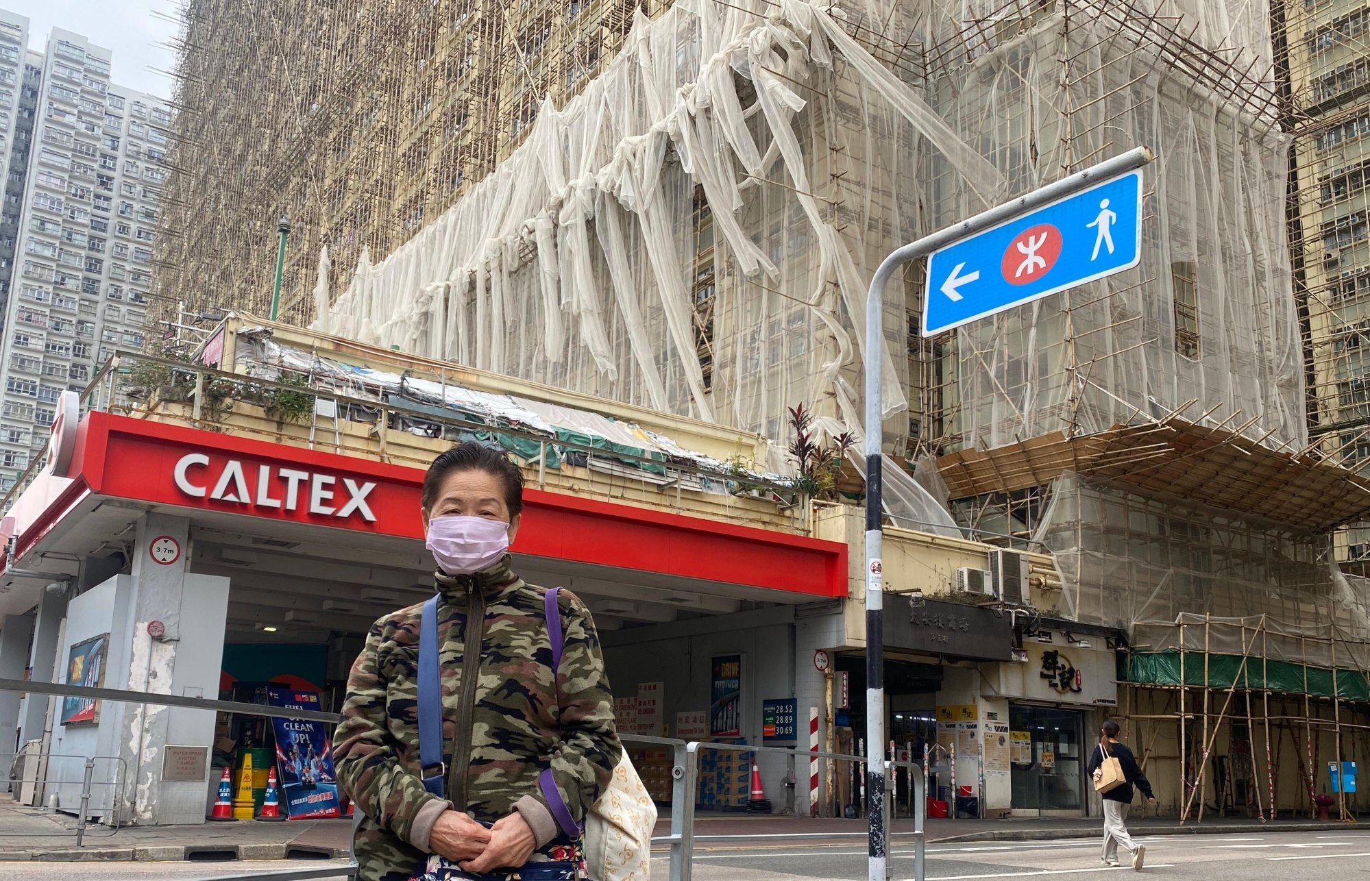 Retiree Tong Yuk-wah, 84, who has lived in Tai On Building for about two decades, says workers began removing some of the scaffolding mesh after the Tai Po fire, but left the task unfinished. Photo: Fiona Sun Retiree Tong Yuk-wah, 84, who has lived in Tai On Building for about two decades, says workers began removing some of the scaffolding mesh after the Tai Po fire, but left the task unfinished. Photo: Fiona Sun
