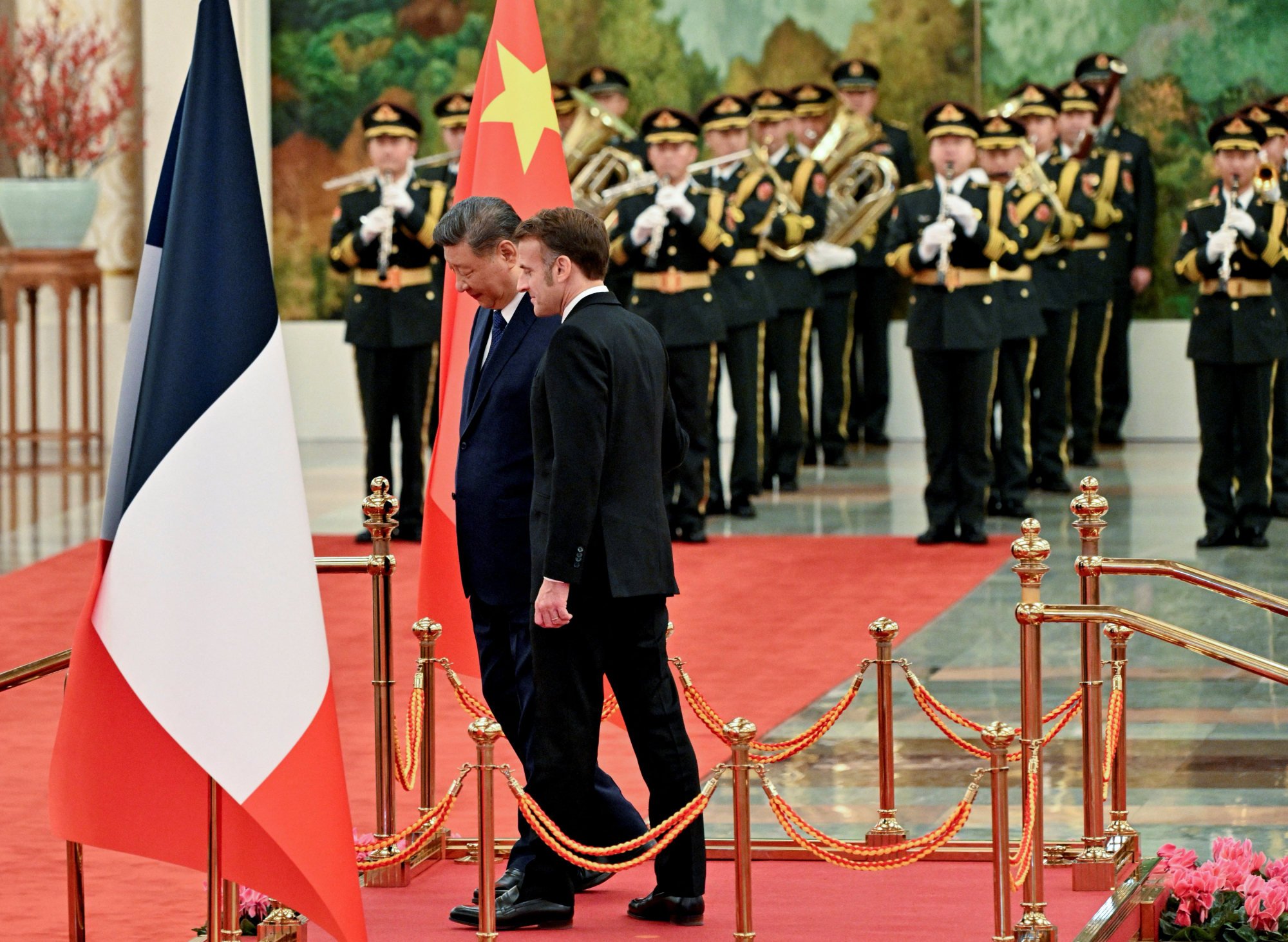 Xi and Macron walk after reviewing an honour guard at the Great Hall of the People on Thursday. Photo: Reuters