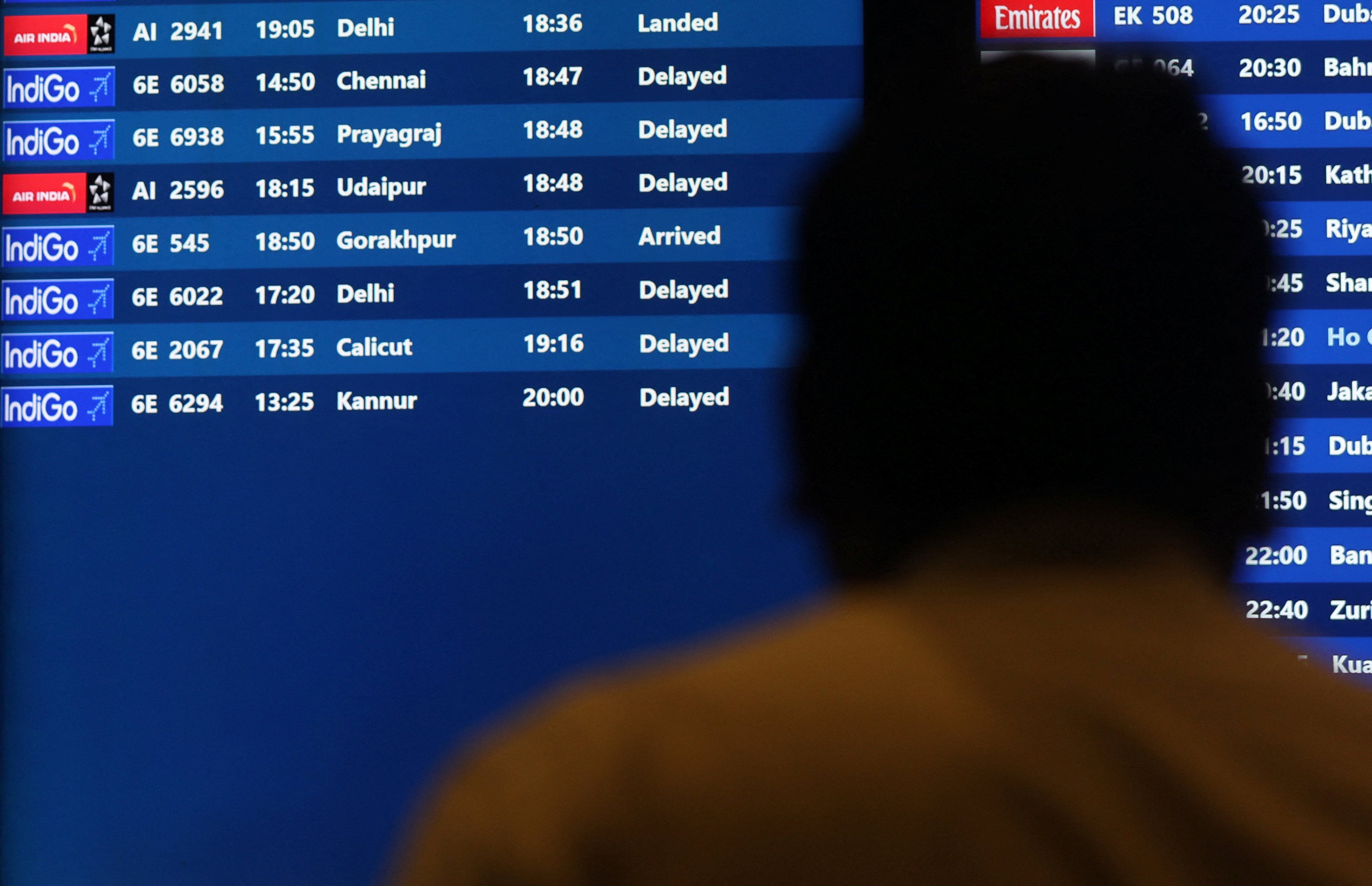 A man looks at a screen displaying delayed IndiGo Airlines flights at Mumbai’s Chhatrapati Shivaji Maharaj International Airport on Wednesday. Photo: Reuters