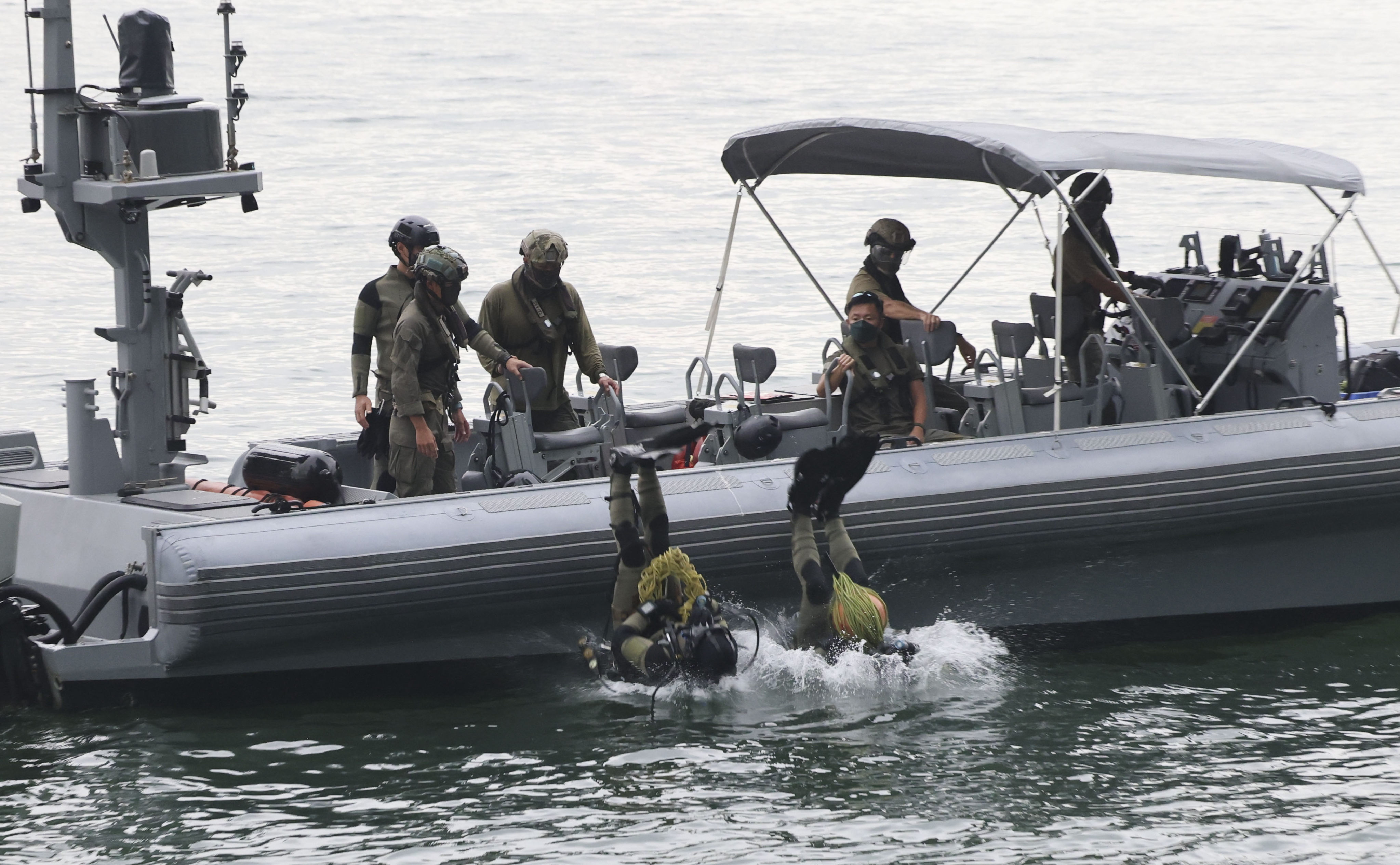 Special Duties Unit membrs dive into the sea to search for evidence in a recent case. Photo: Jelly Tse