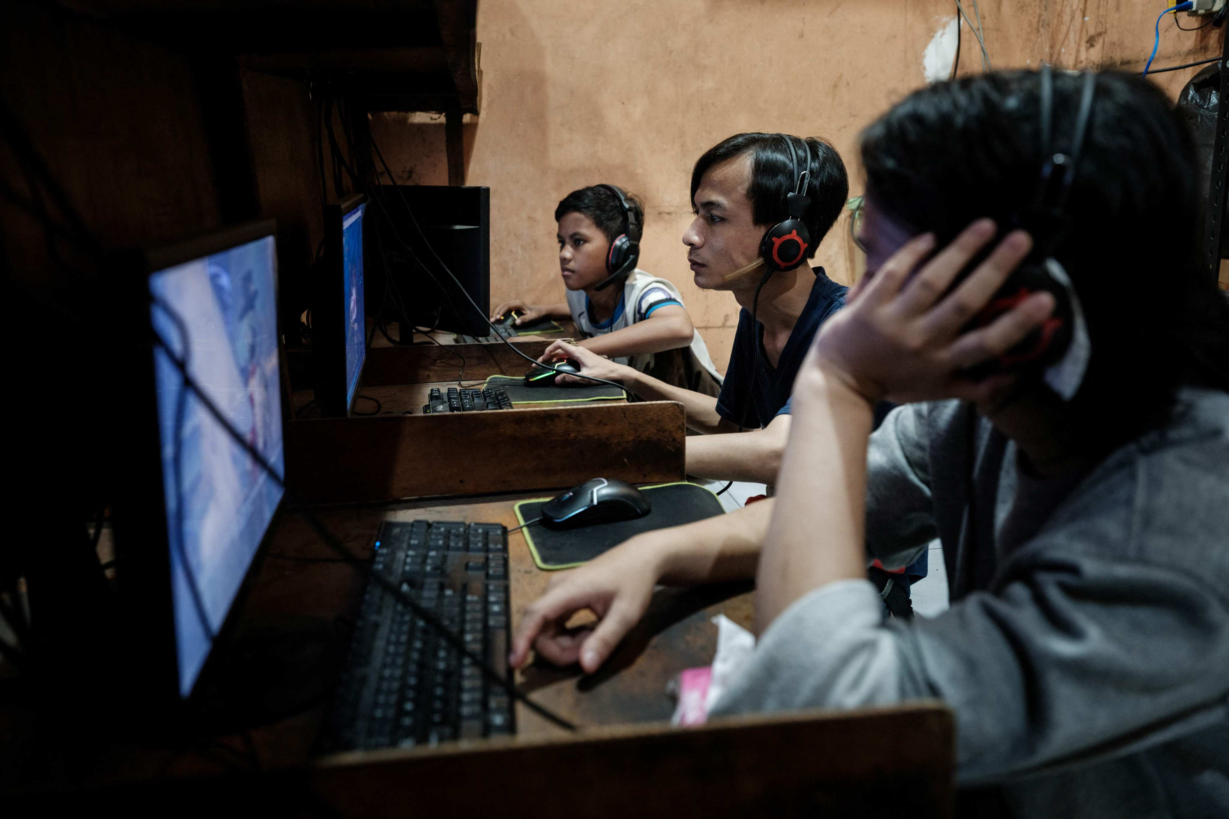 Young men play online games and surf the internet at a cyber cafe in Jakarta last month. Photo: AFP