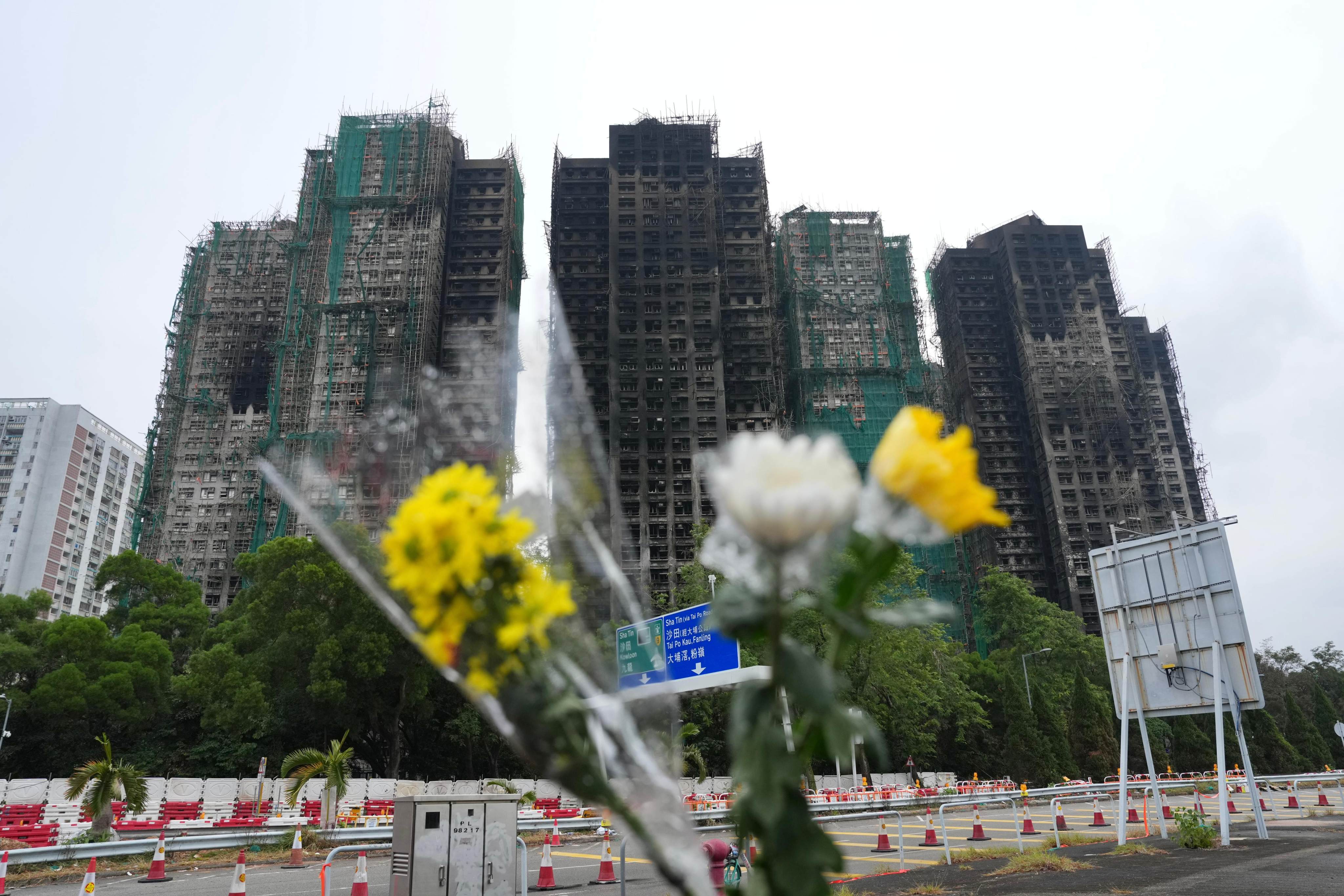 Flowers are placed near Wang Fuk Court in Tai Po after last week’s deadly blaze. Photo: Karma Lo