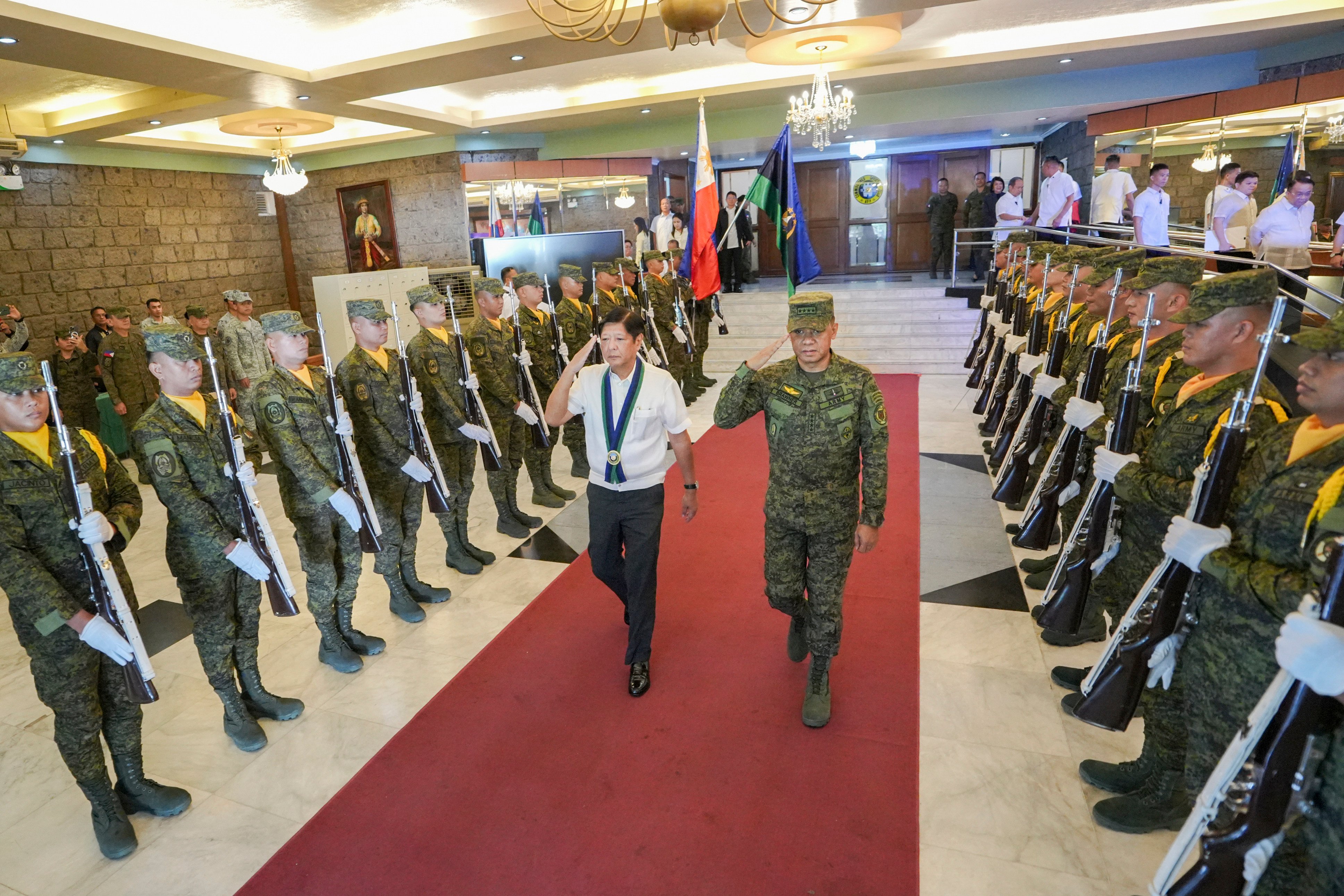 Philippine President Ferdinand Marcos Jnr walks with armed forces chief General Romeo Brawner Jnr at Camp Aguinaldo in Quezon City in July 2024. Brawner has since confirmed that the military is investigating alleged destabilisation efforts involving retired officers. Photo: AP