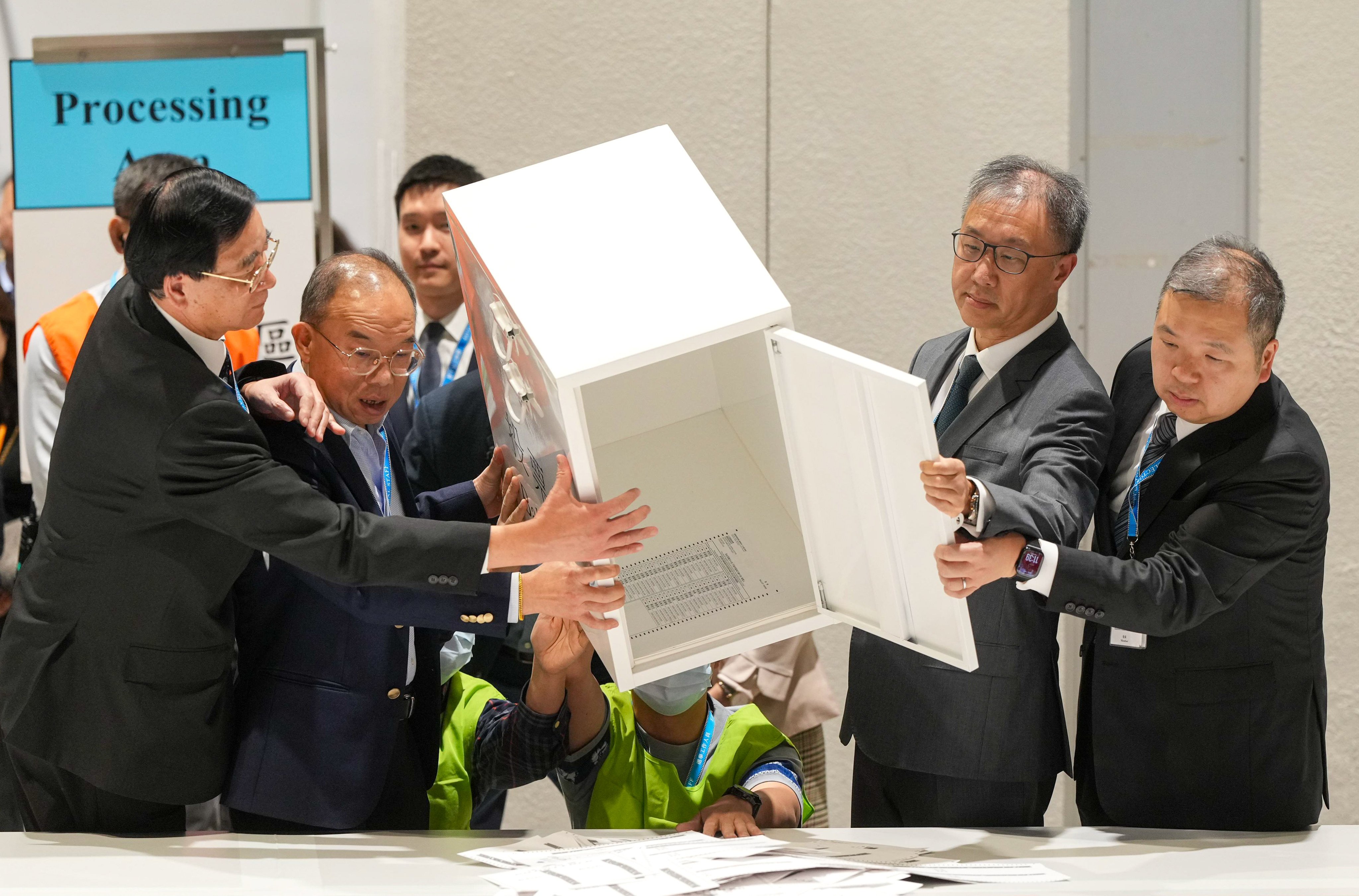 Secretary for Constitutional and Mainland Affairs Erick Tsang (second left), and Electoral Affairs Commission chief Justice David Lok empty a ballot box. Photo: Sam Tsang