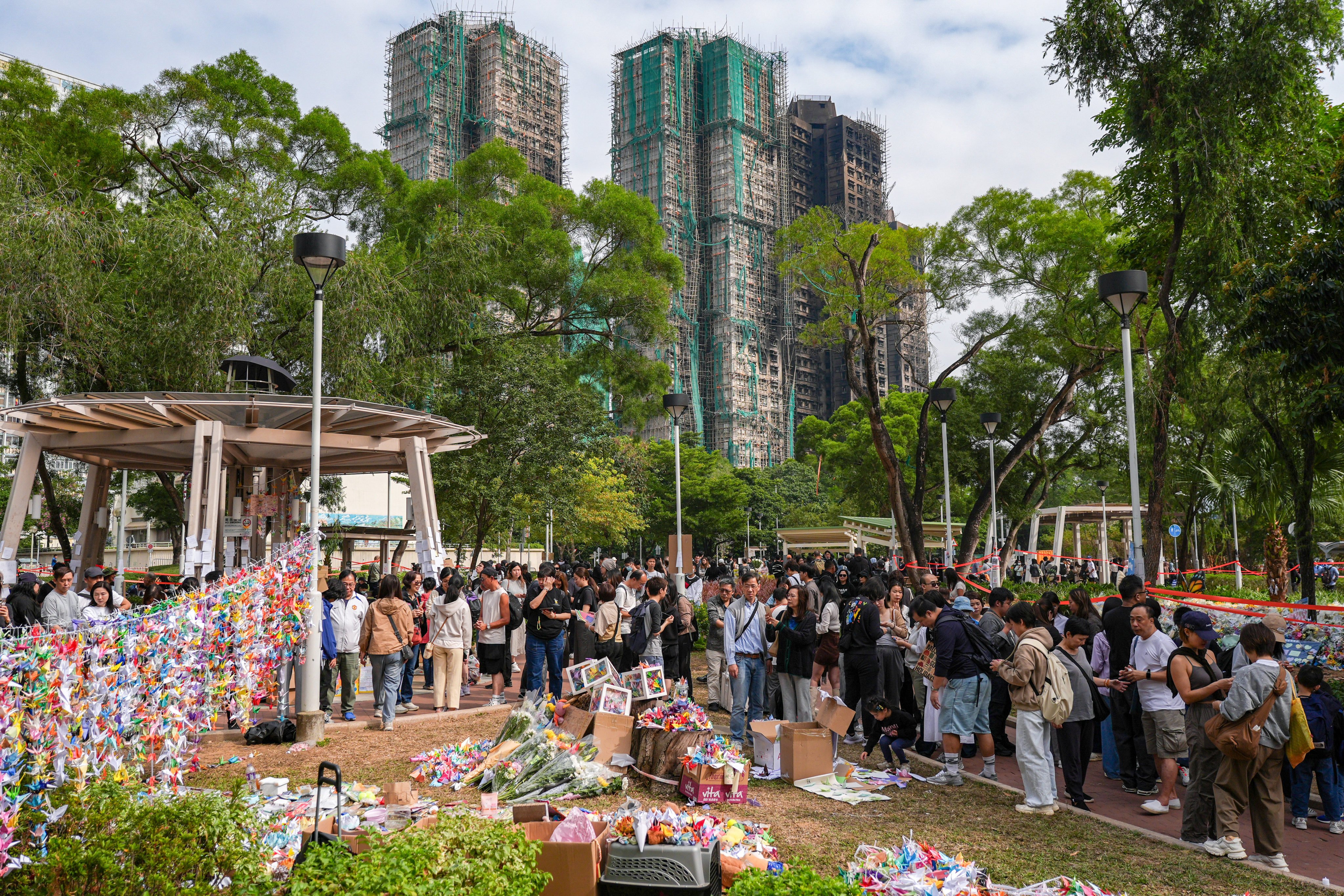 Mourners gather at the Kwong Fuk Sitting-out Area after the deadly fire at Wang Fuk Court in Tai Po. Photo: Eugene Lee
