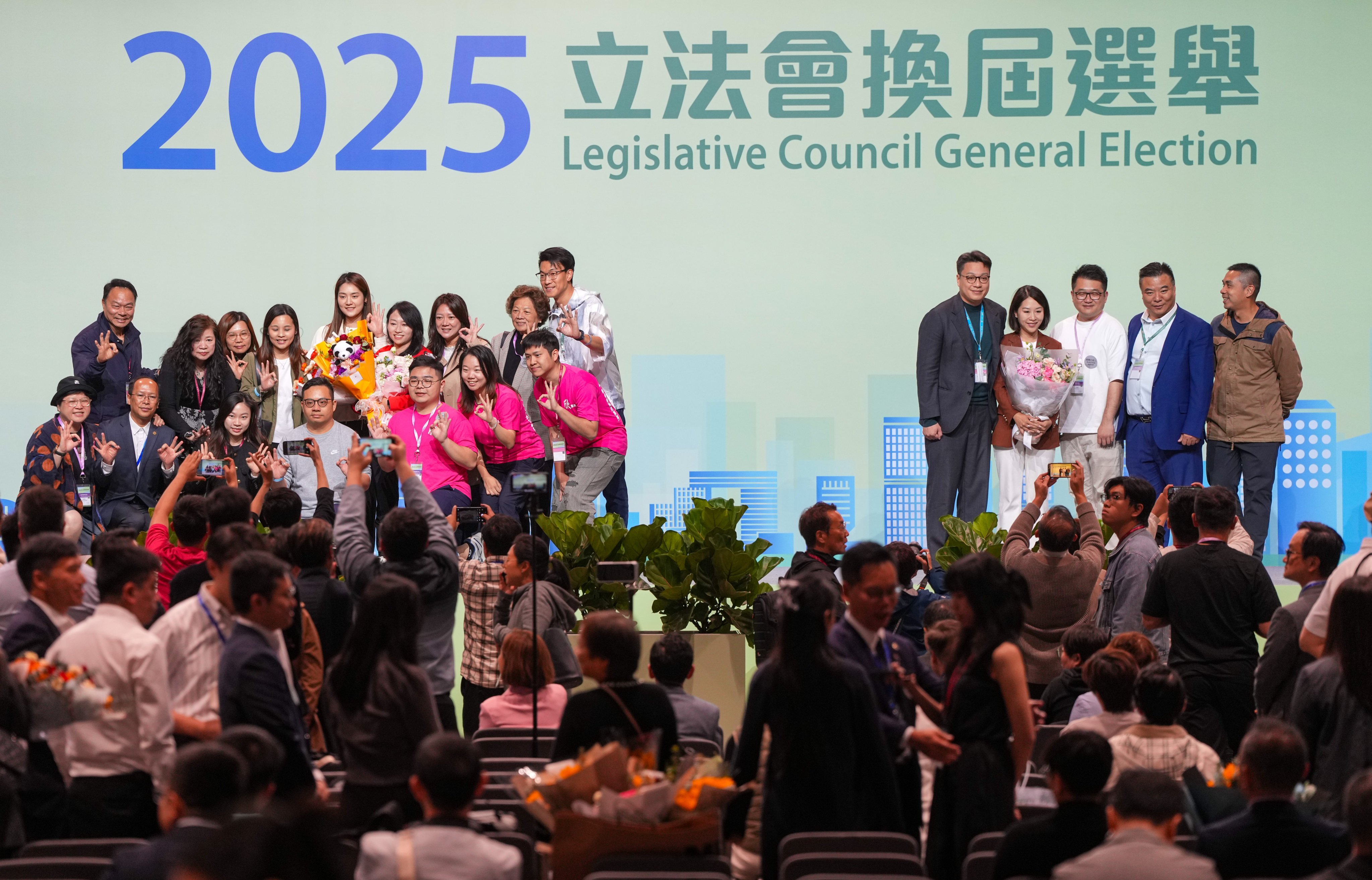 Winners and their supporters pose for pictures in the Hong Kong Convention and Exhibition Centre in Wan Chai on Monday. Photo: Sam Tsang