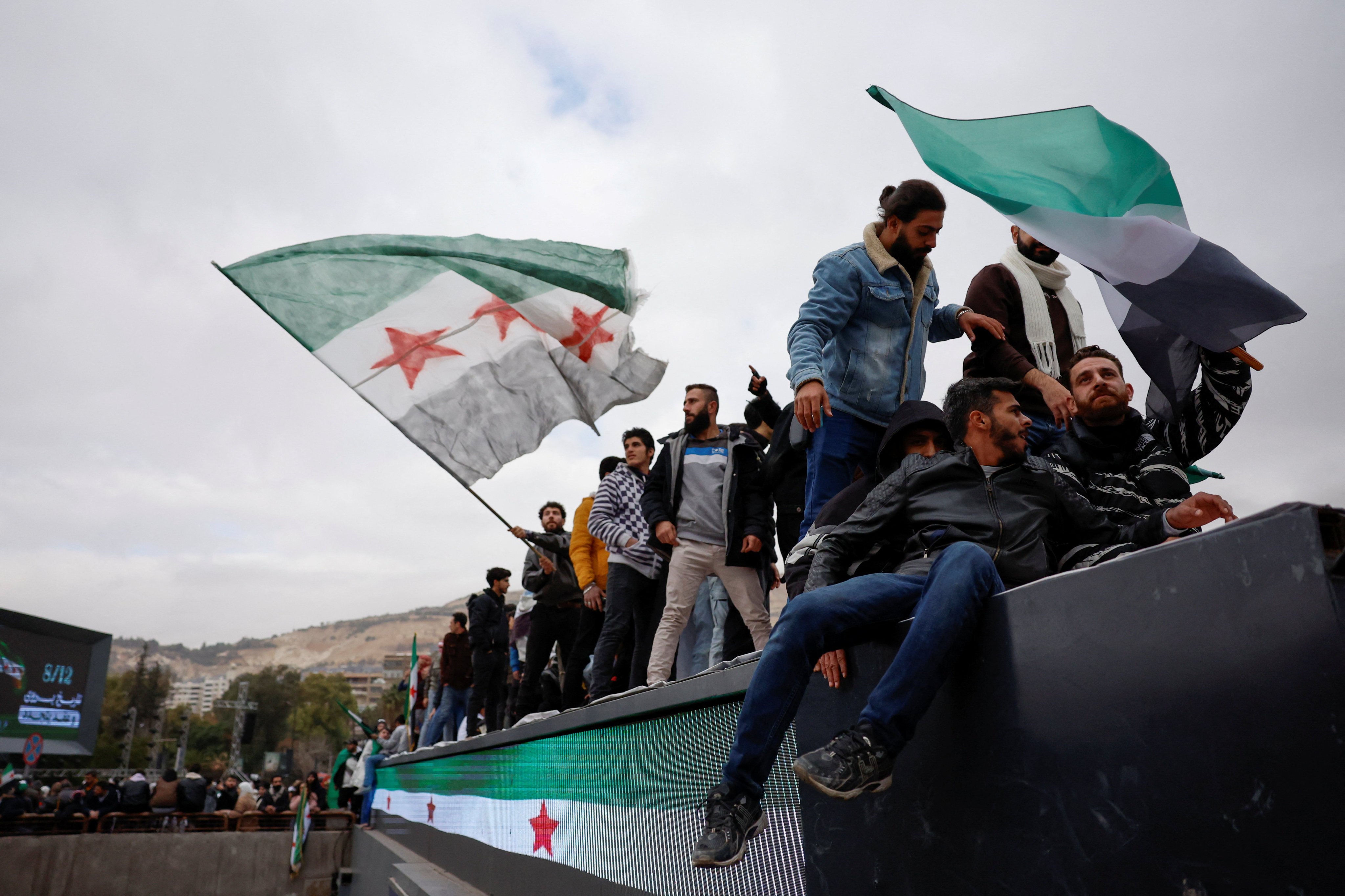 People gather as they celebrate the first anniversary of Bashar al-Assad’s fall, at Ummayad Square in Damascus, Syria on Monday. Photo: Reuters