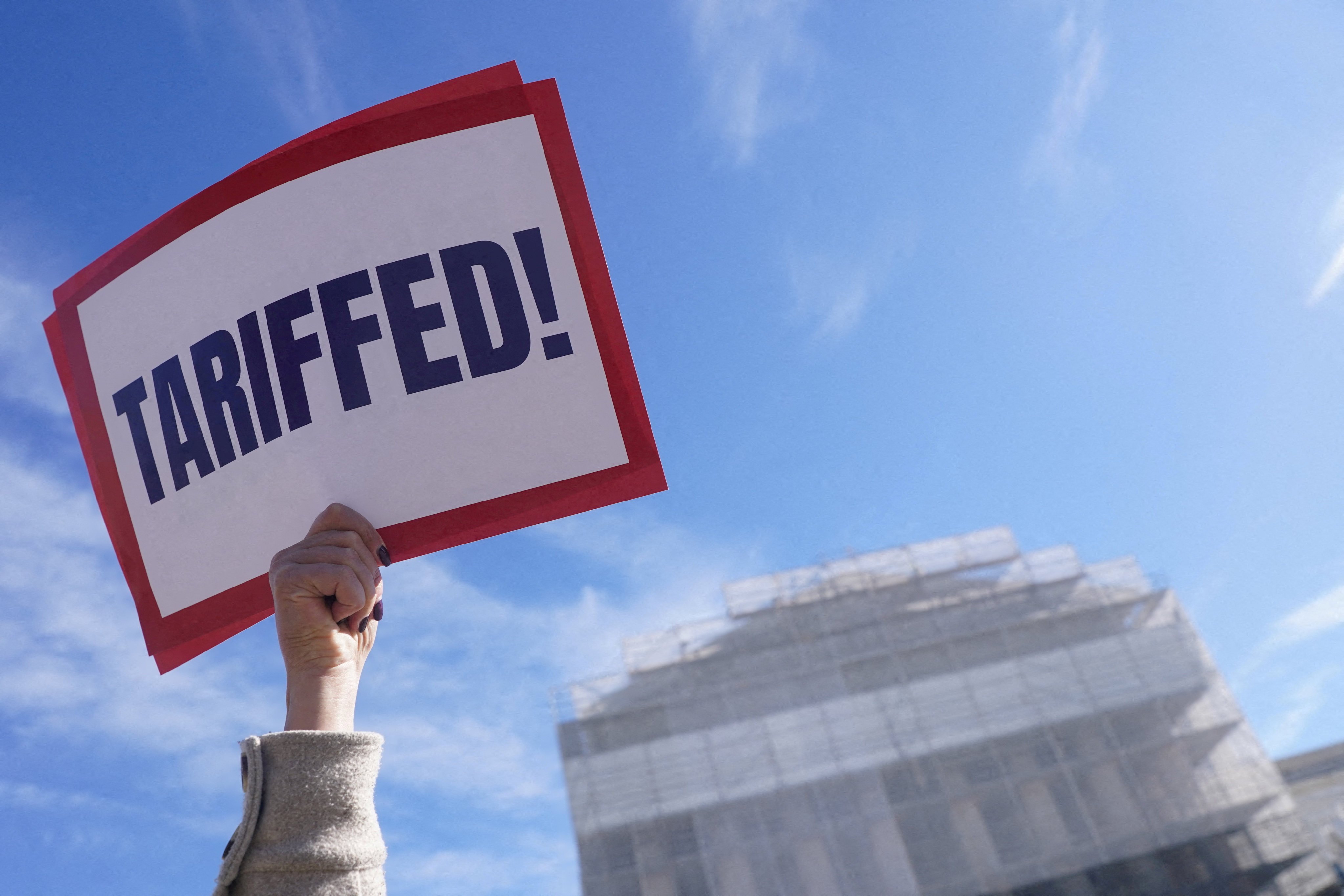 A protester holds a sign outside the US Supreme Court on November 5, 2025. Photo: Reuters