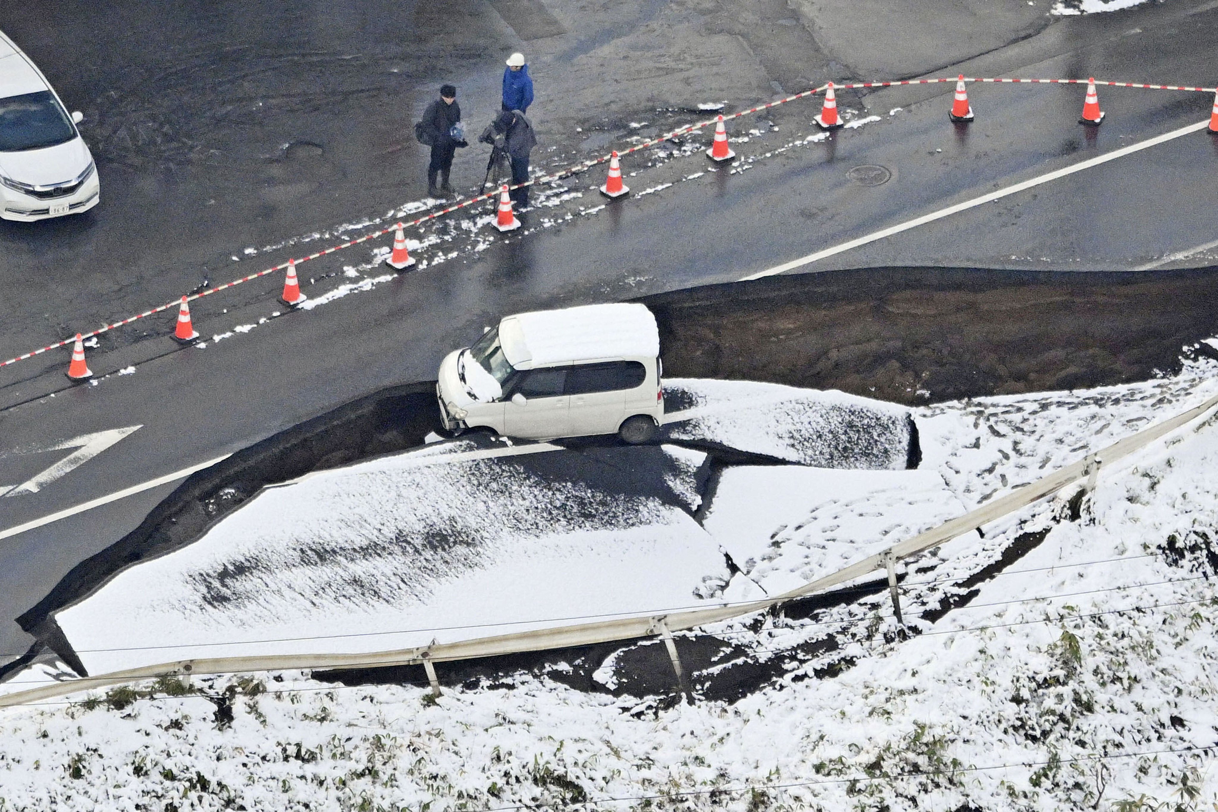 A vehicle sits on a damaged road in Tohoku town, Japan’s Aomori prefecture, on Tuesday. Photo: Kyodo News via AP